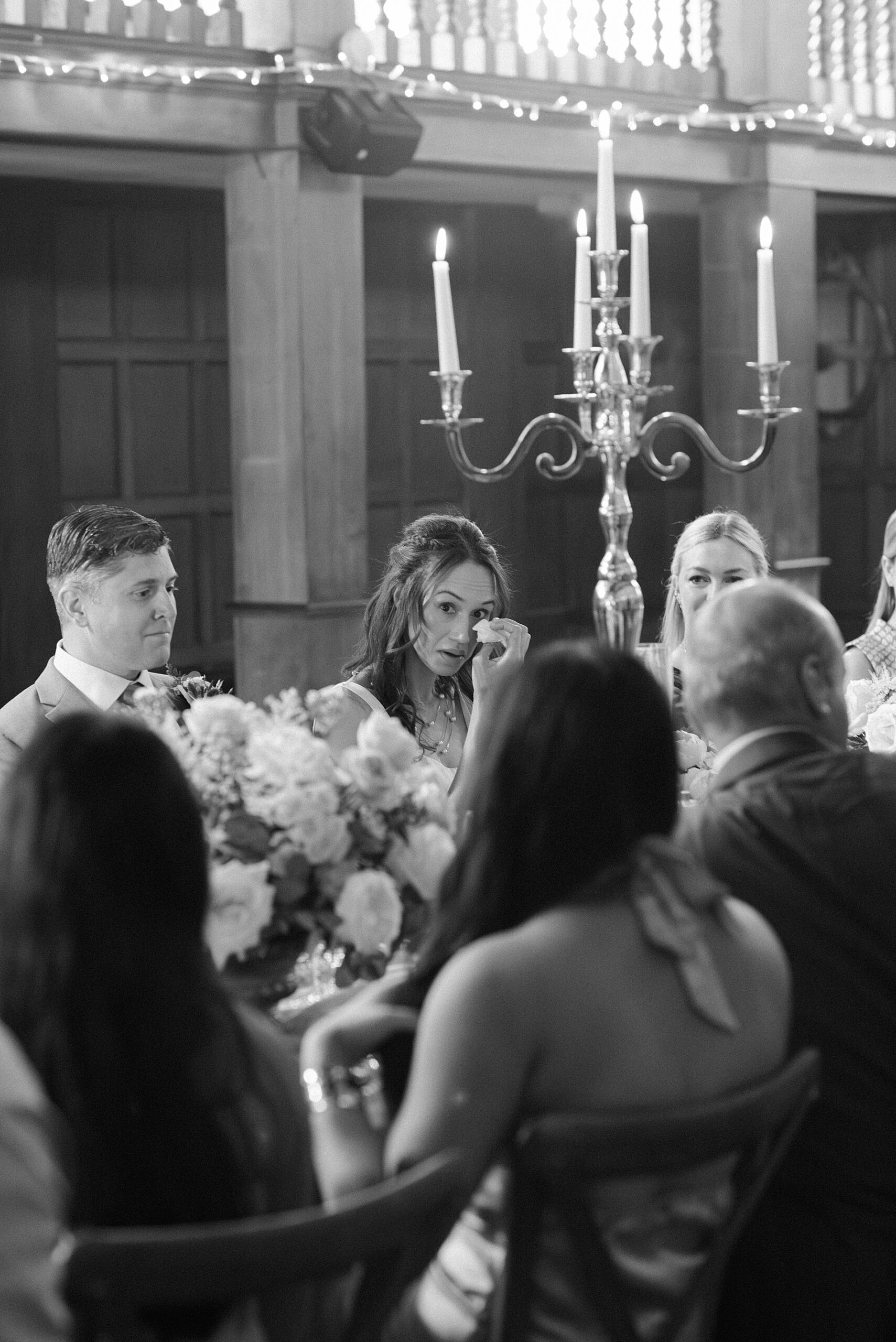 bride wipes away tears during wedding reception 