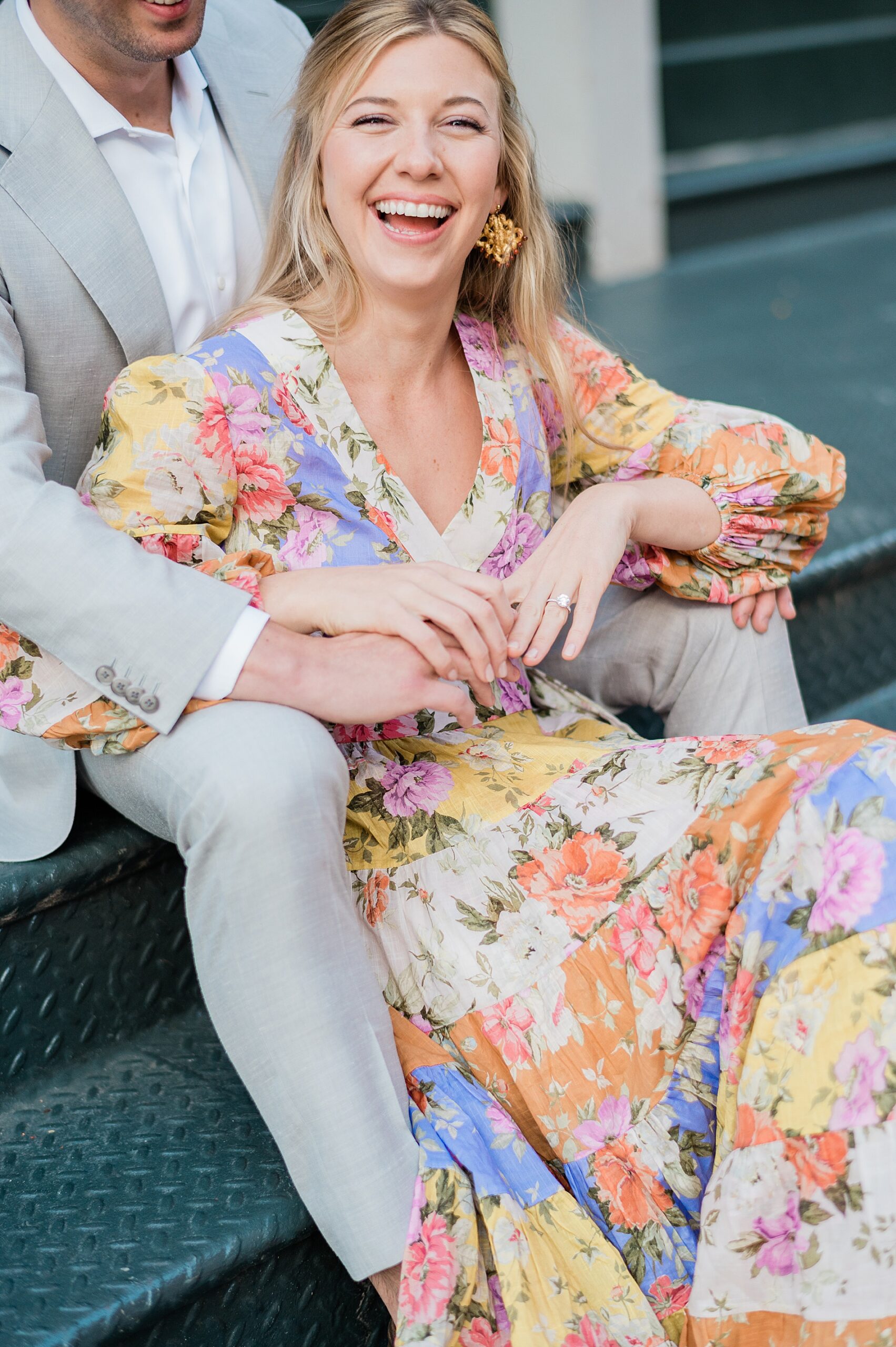 woman smiles as she sits with her fiancé