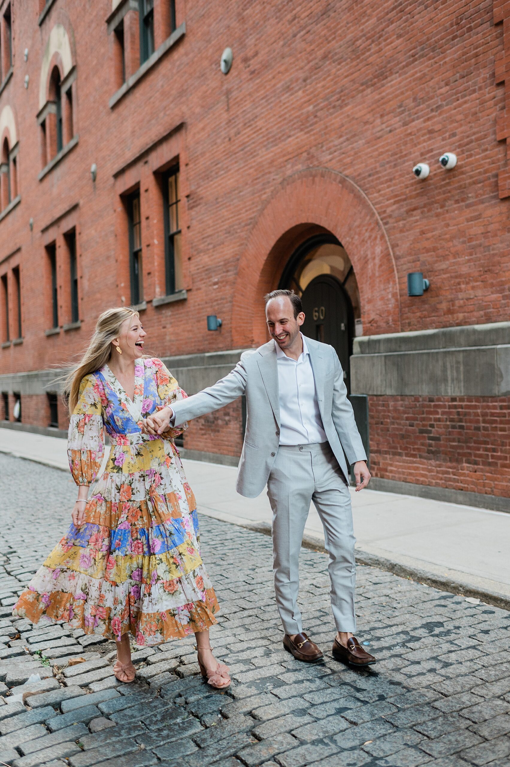candid engagement photos of couple laughing 
