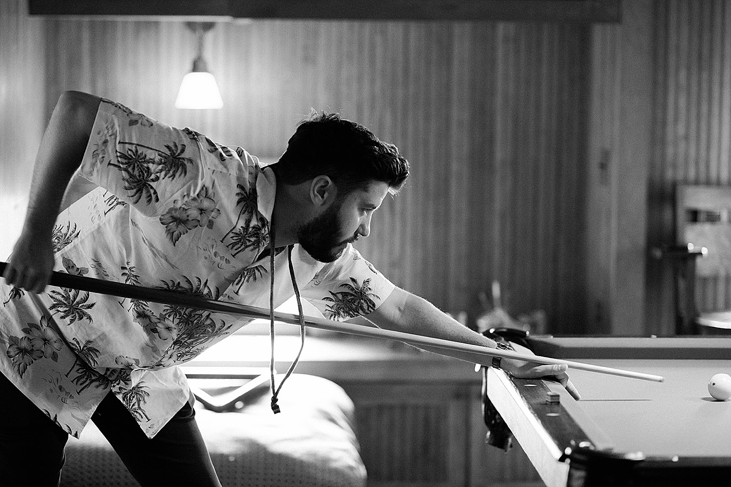 groom playing pool before wedding day