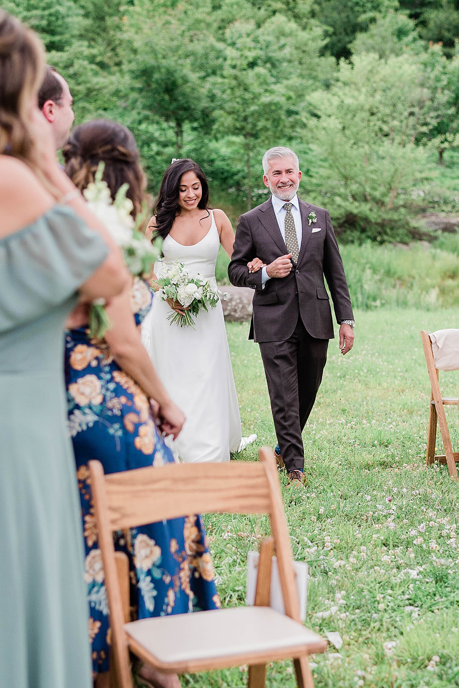 bride walks down the aisle with father