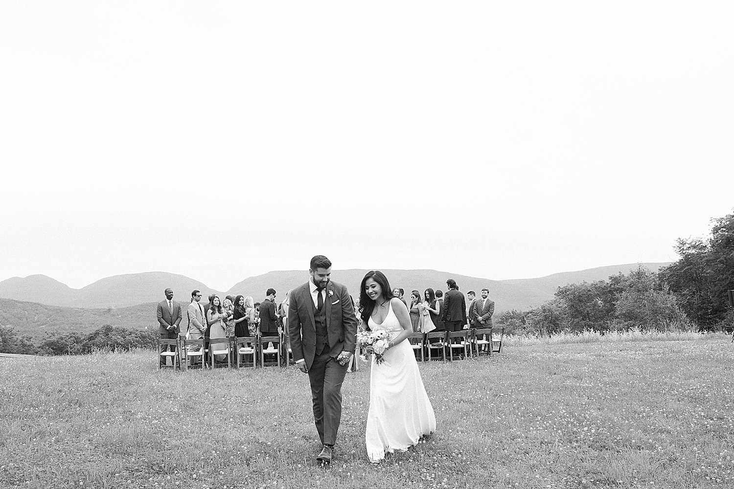 newlyweds exit outdoor wedding ceremony
