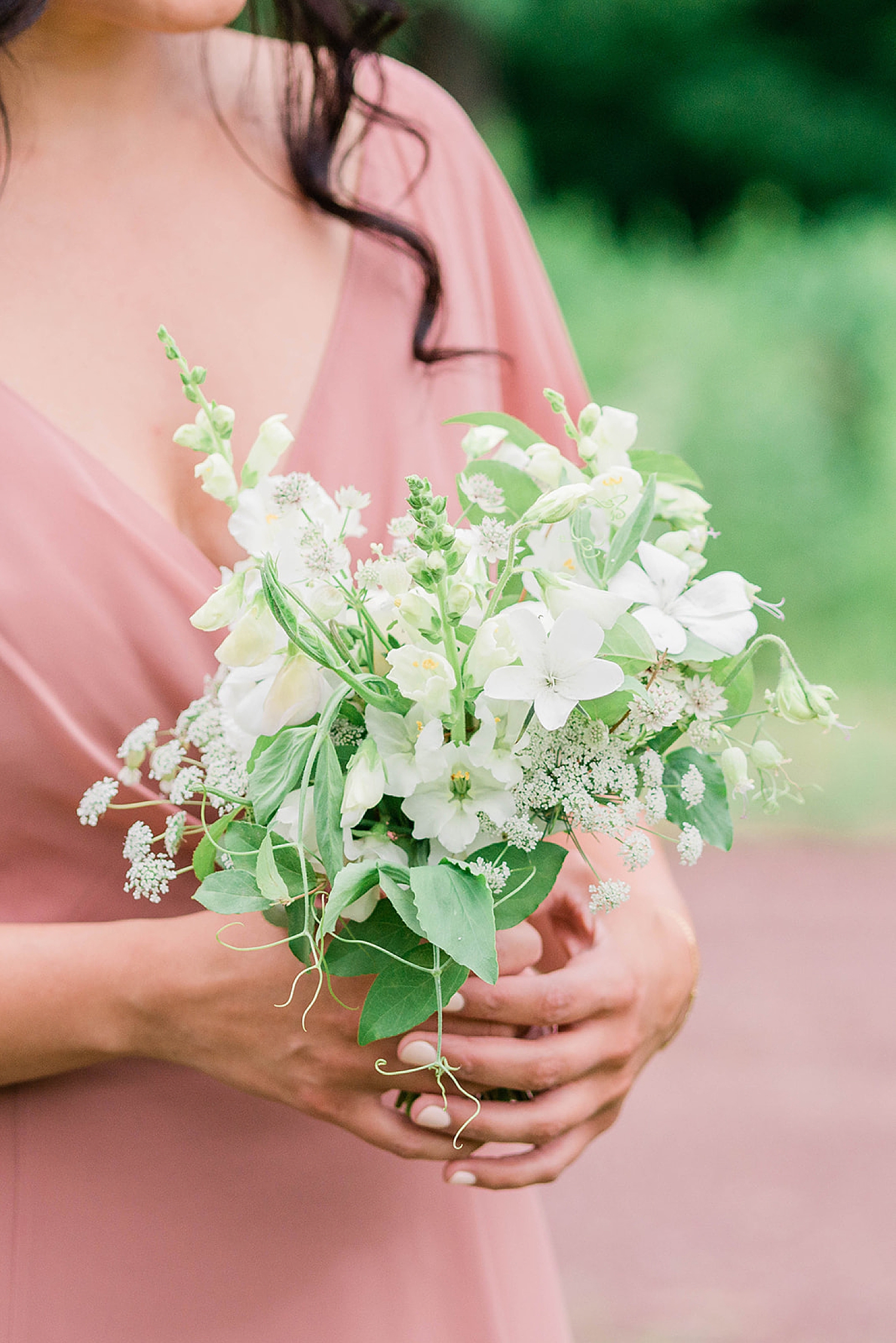 bridesmaid in light pink dress and class bouquet