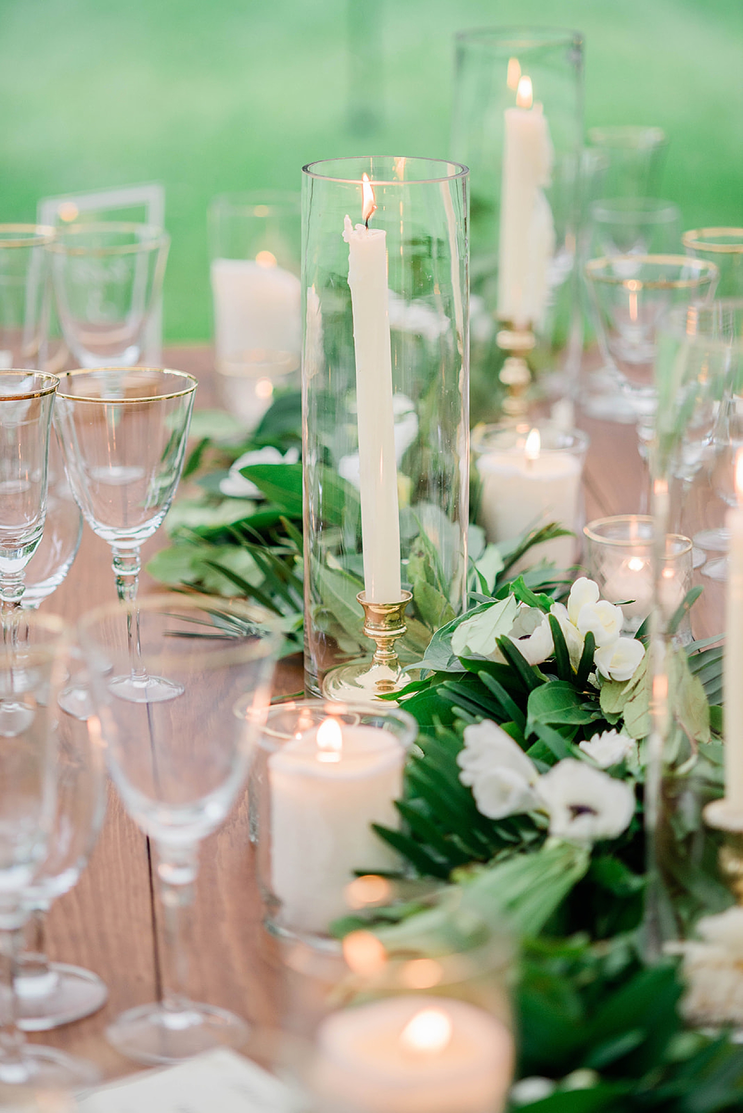 candles and greenery decorate tables at reception