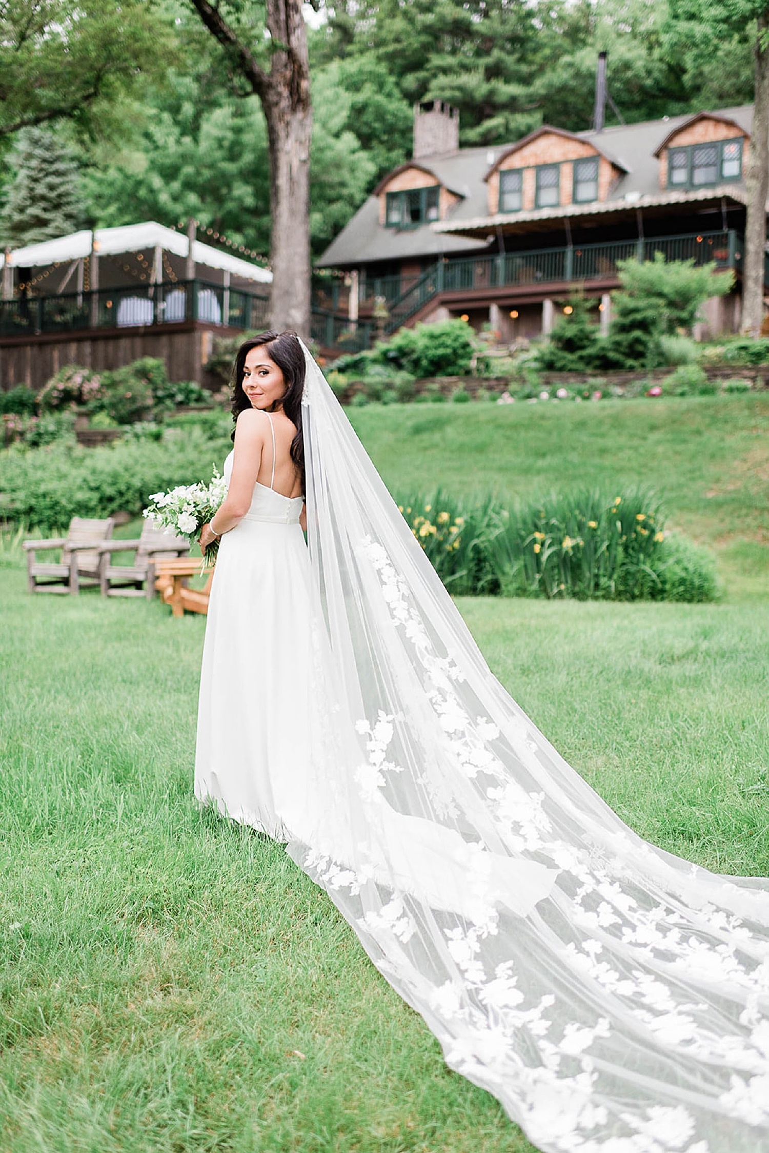 bride with cathedral length veil trailing behind