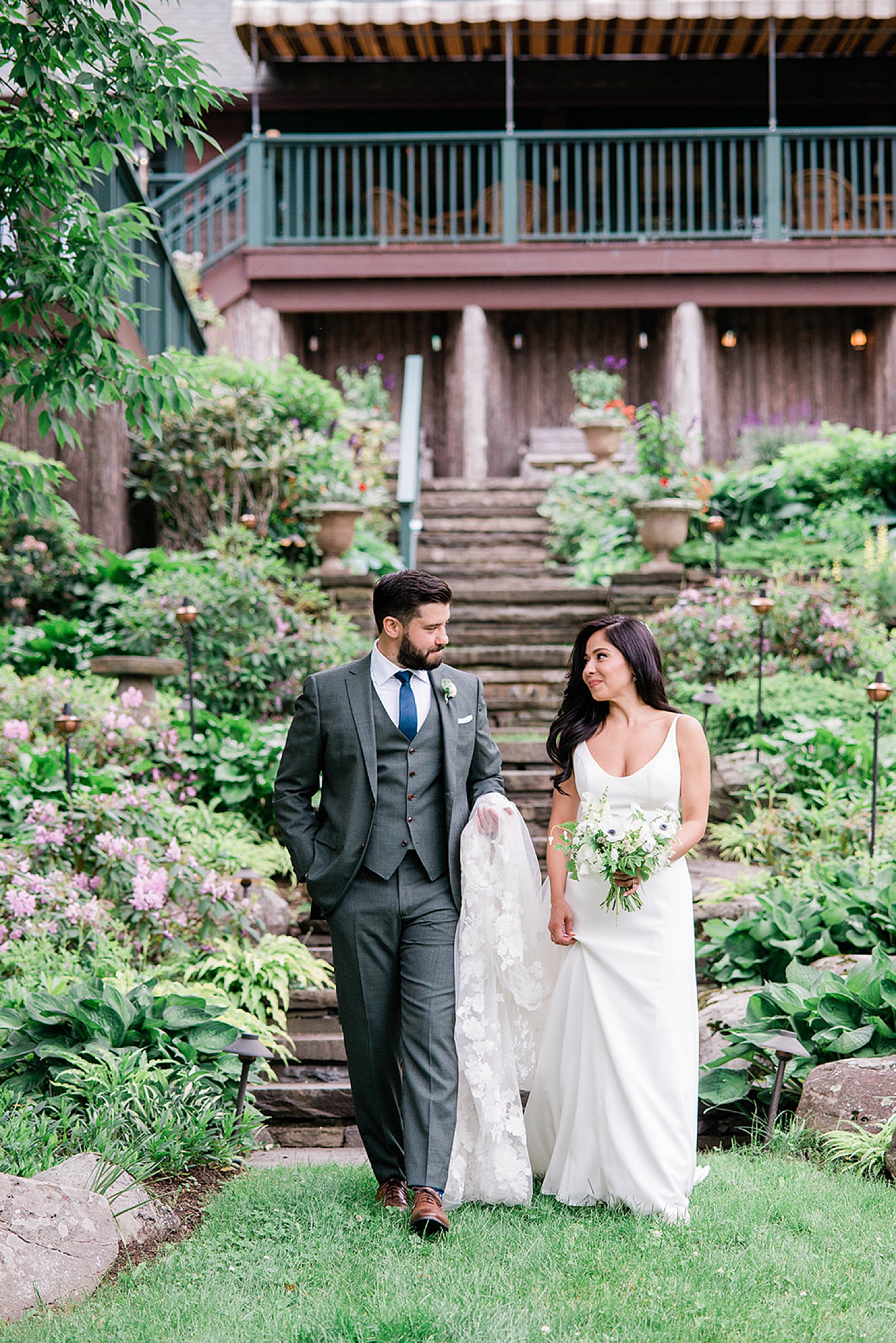 bride and groom walk down stairs at Deer Mountain Inn
