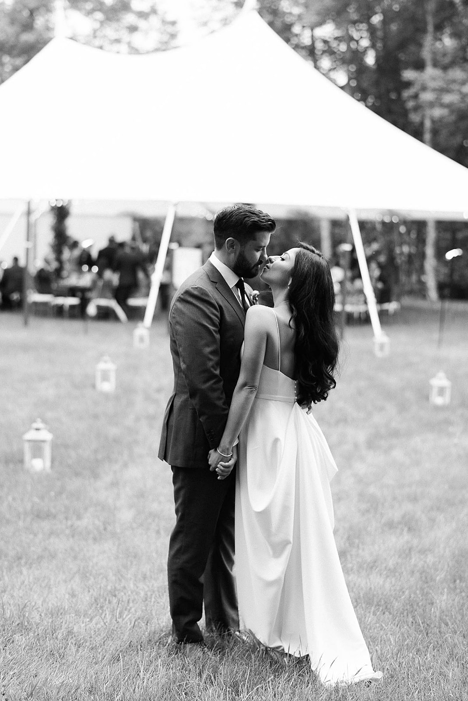 newlyweds kiss outside of tent