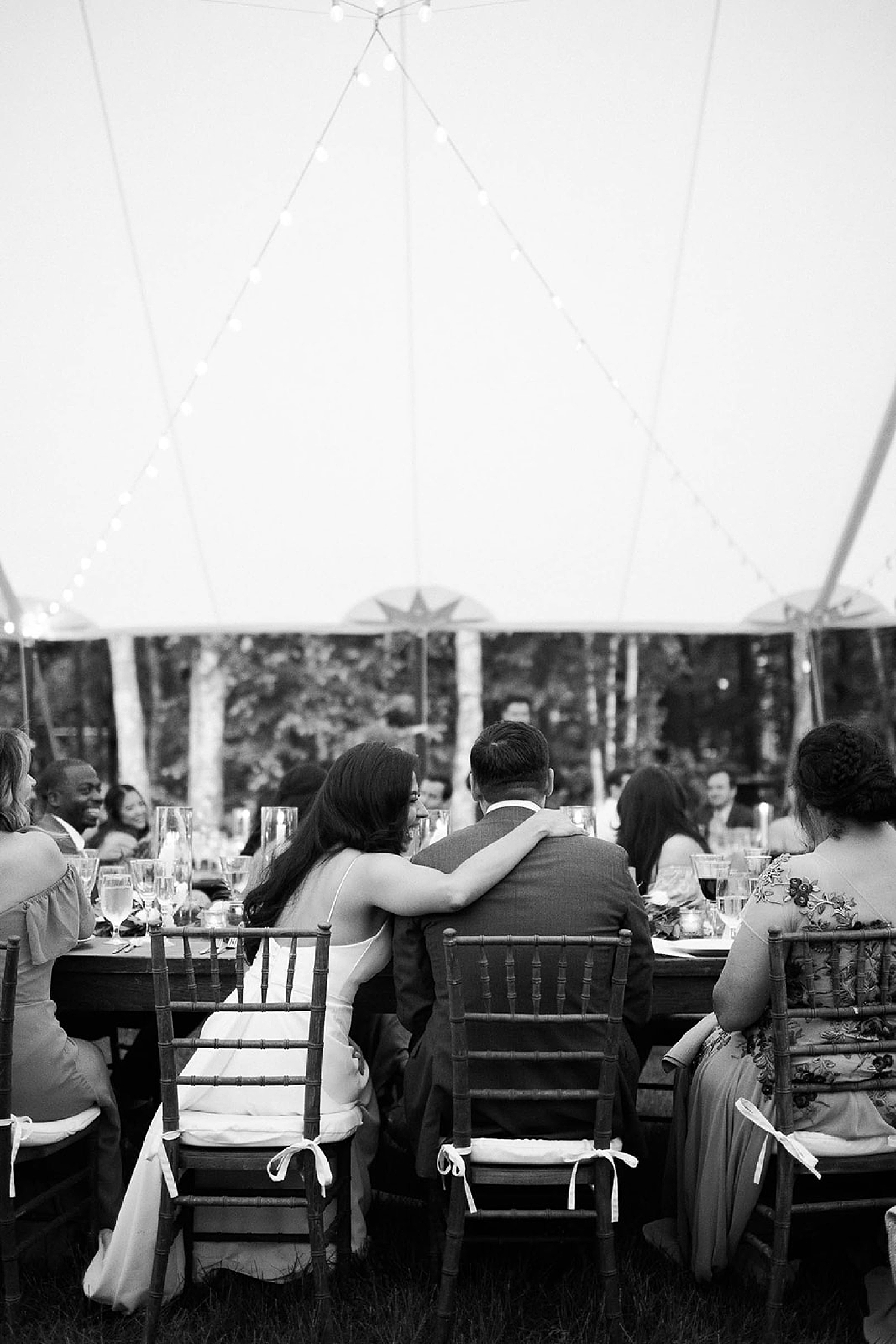 candid moment during reception of bride and groom hugging