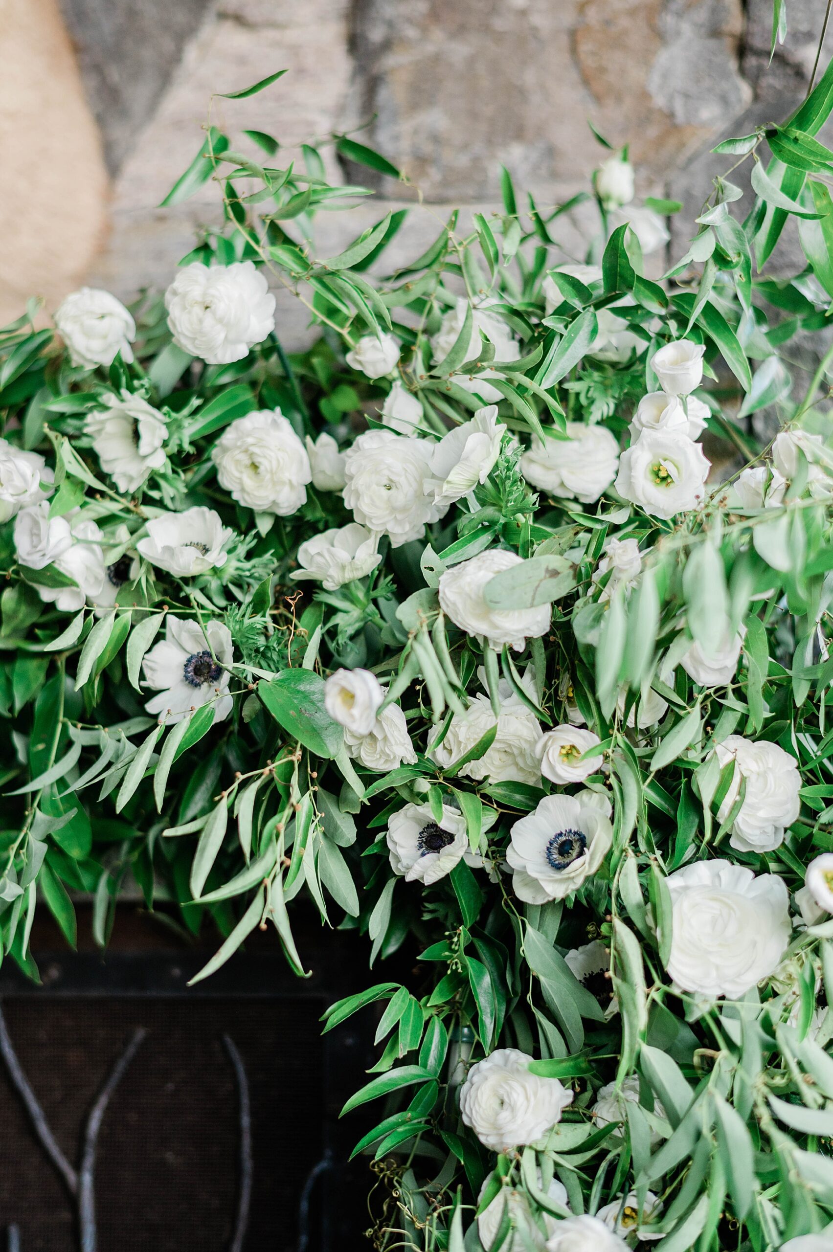 cascading flowers on mantel during wedding ceremony