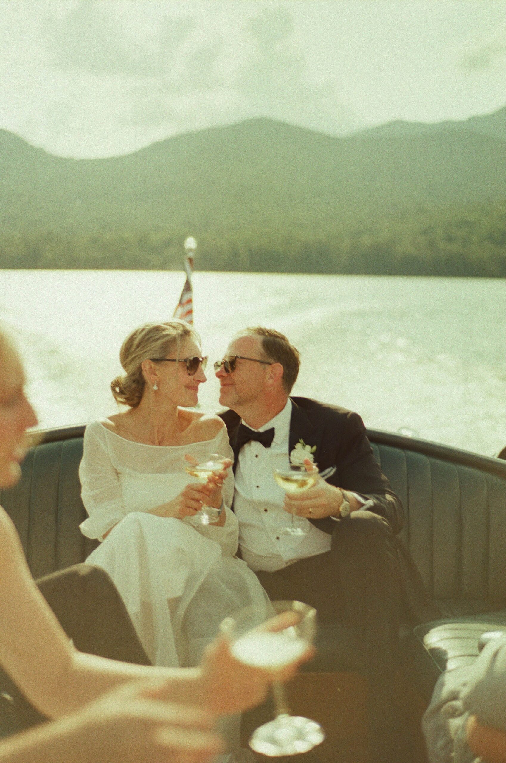 bride and groom share glass of champagne