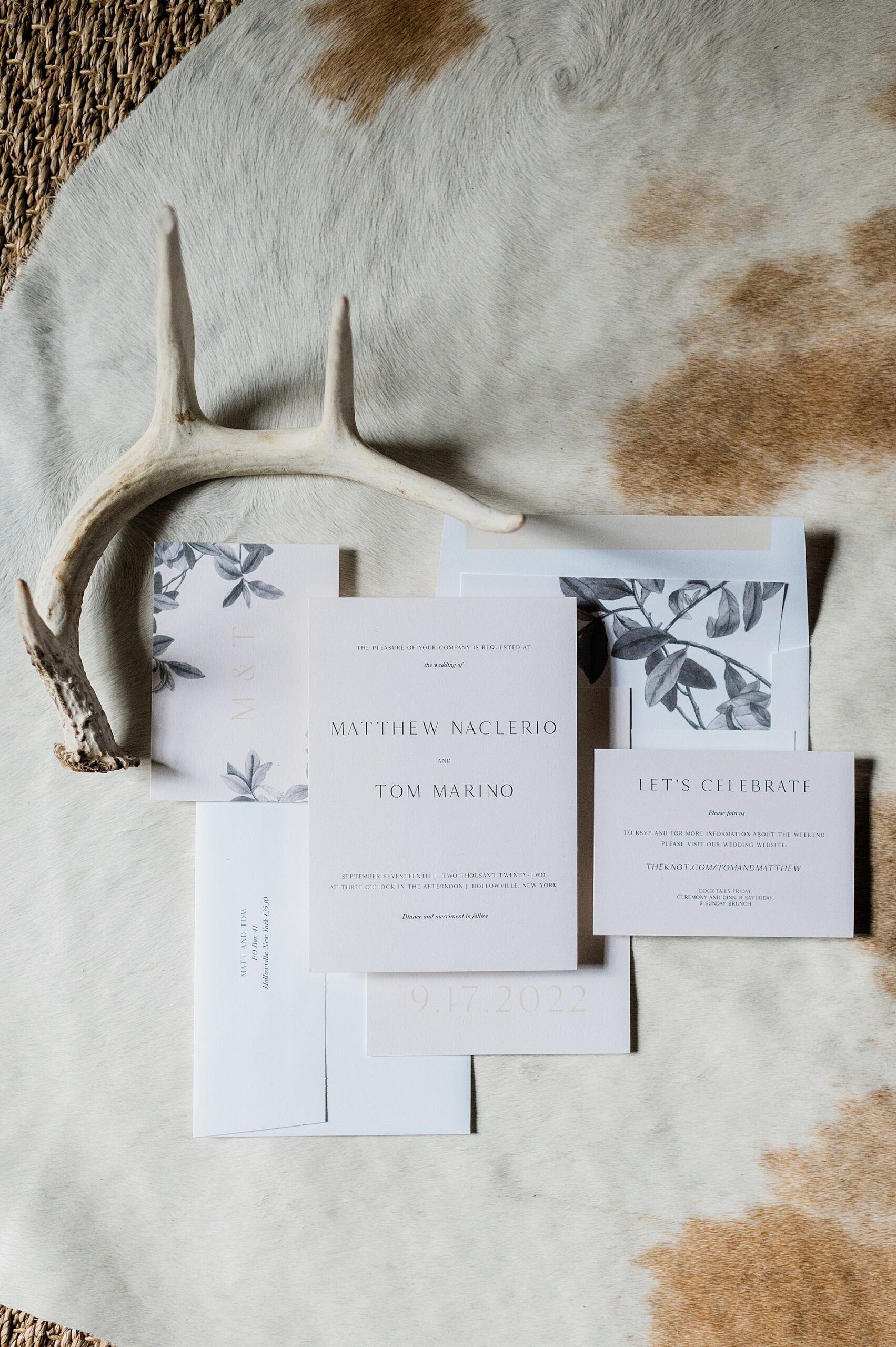 classic and clean wedding invitation on cowhide rug