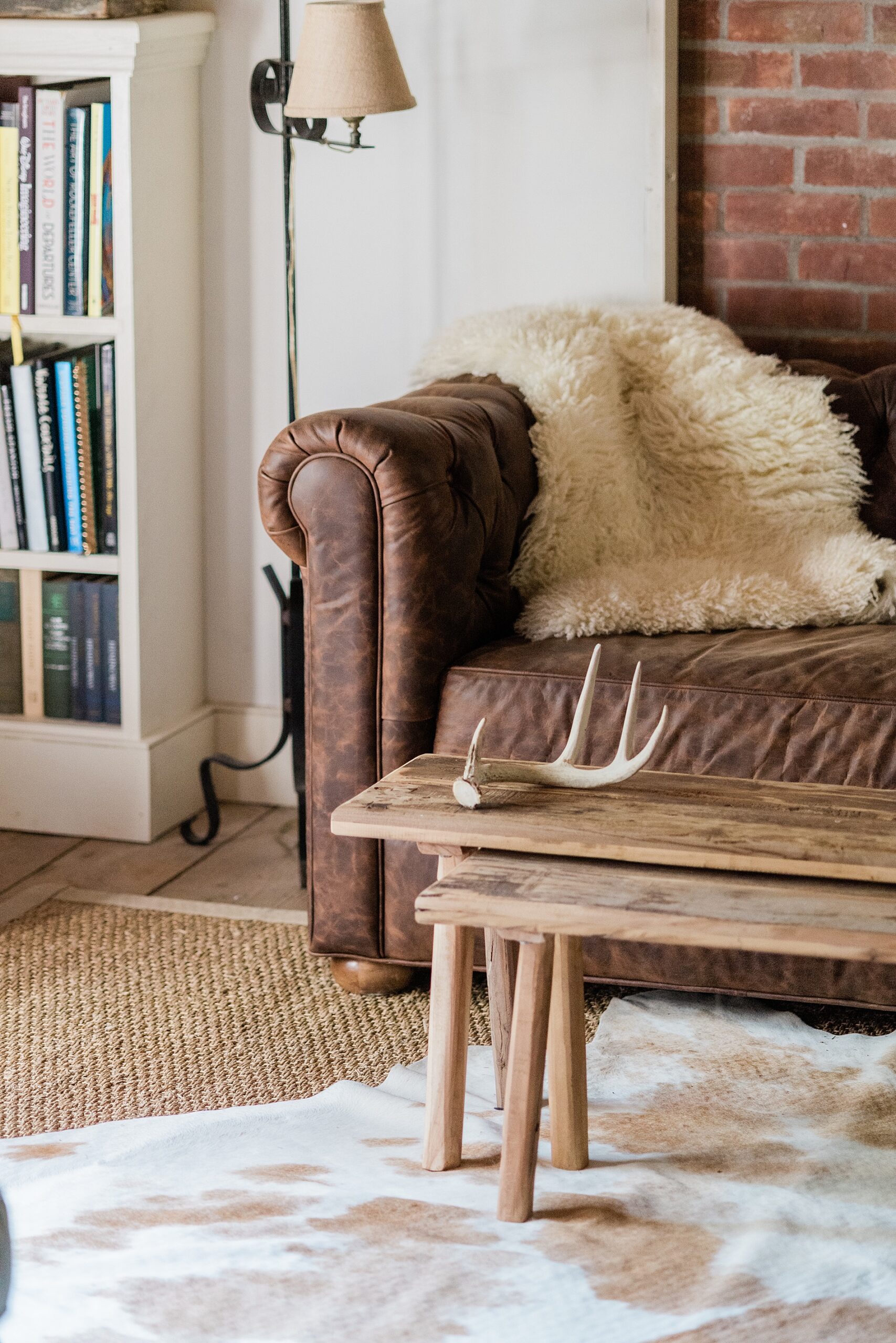 couch and wooden table on cow hide rug