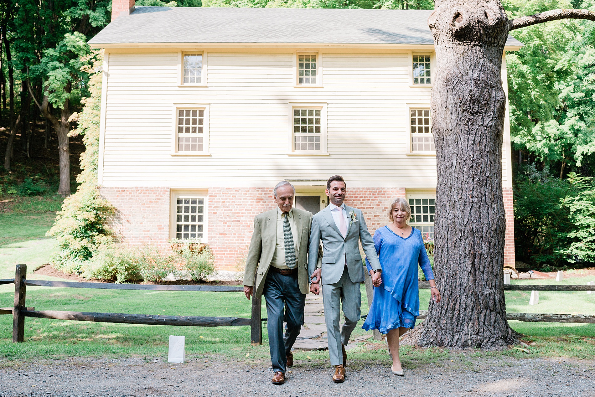 parents walk their son down the aisle