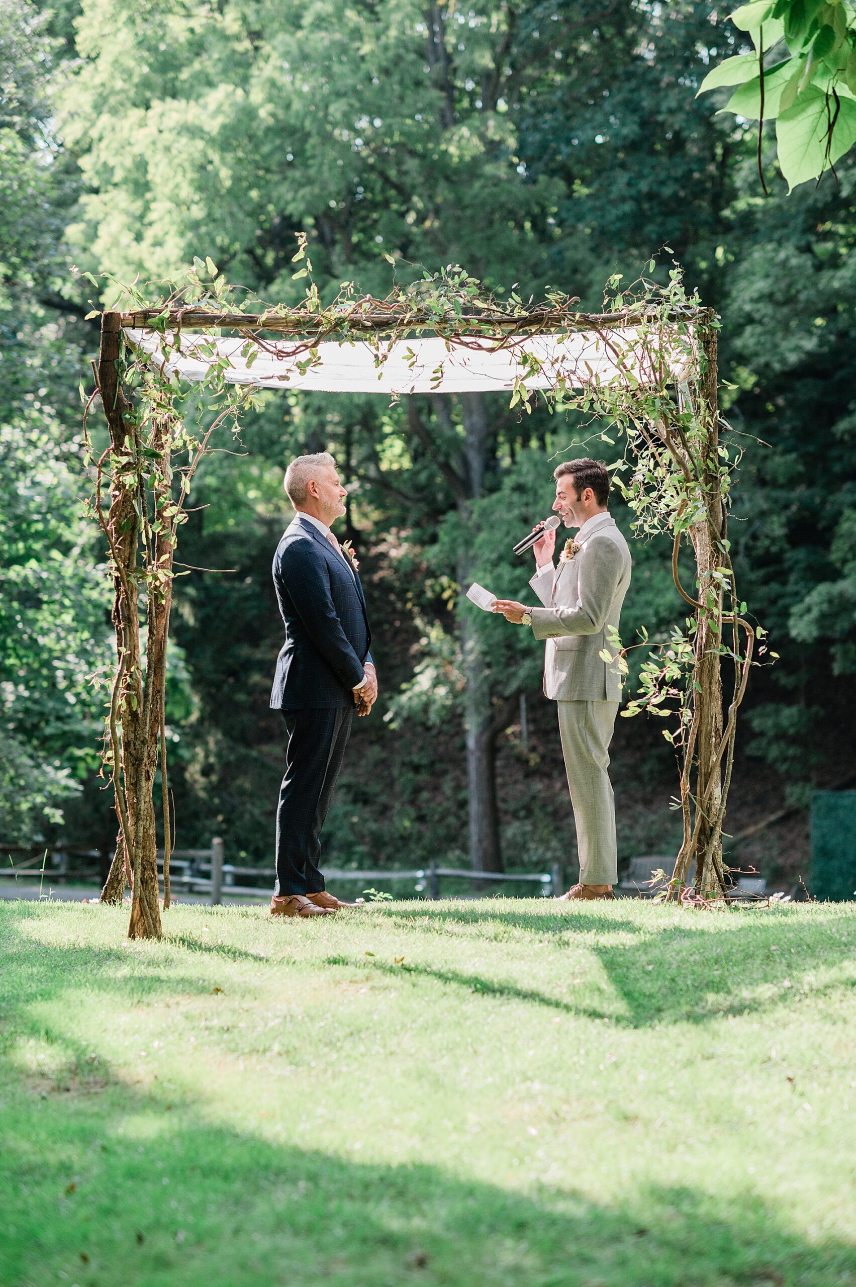 grooms exchange written vows at wedding ceremony