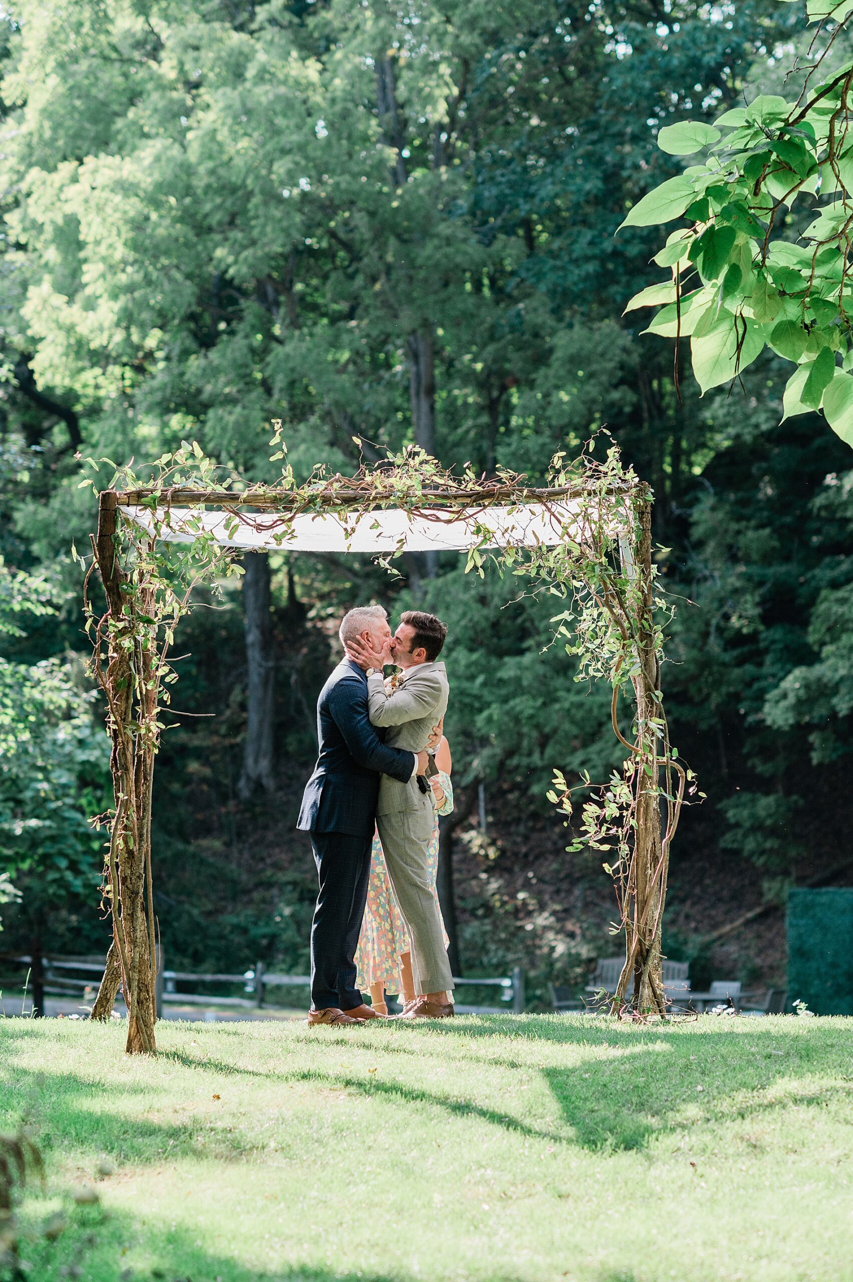 grooms kiss at wedding ceremony