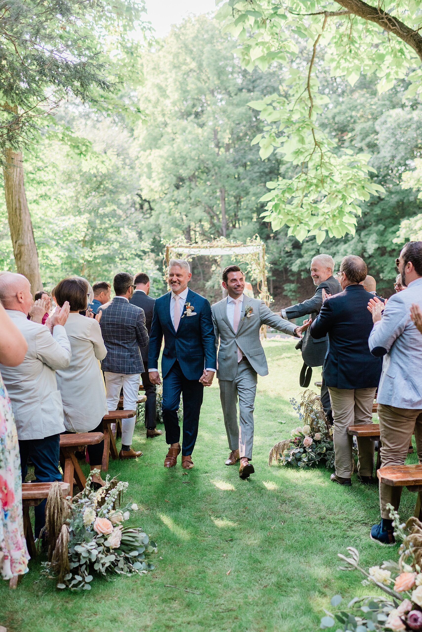 grooms exit wedding ceremony at private estate
