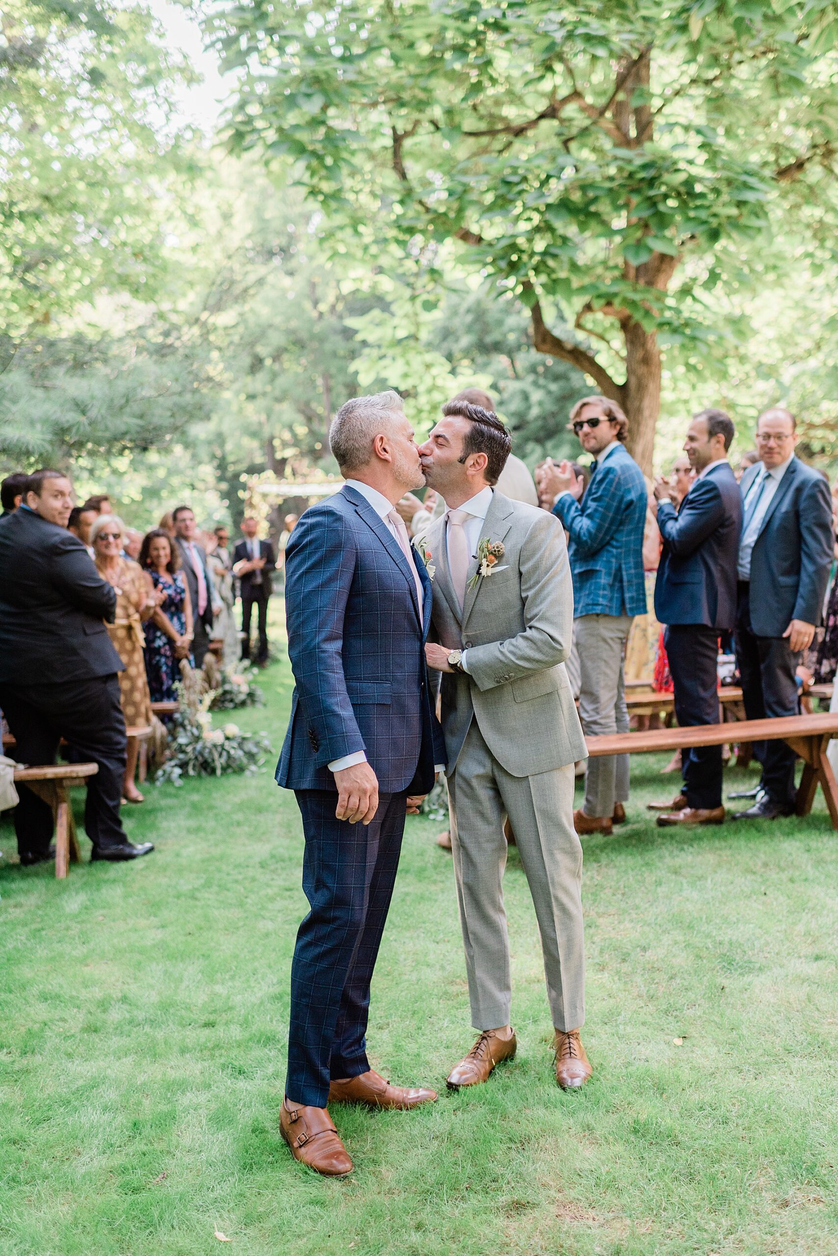 grooms kiss as they exit wedding ceremony