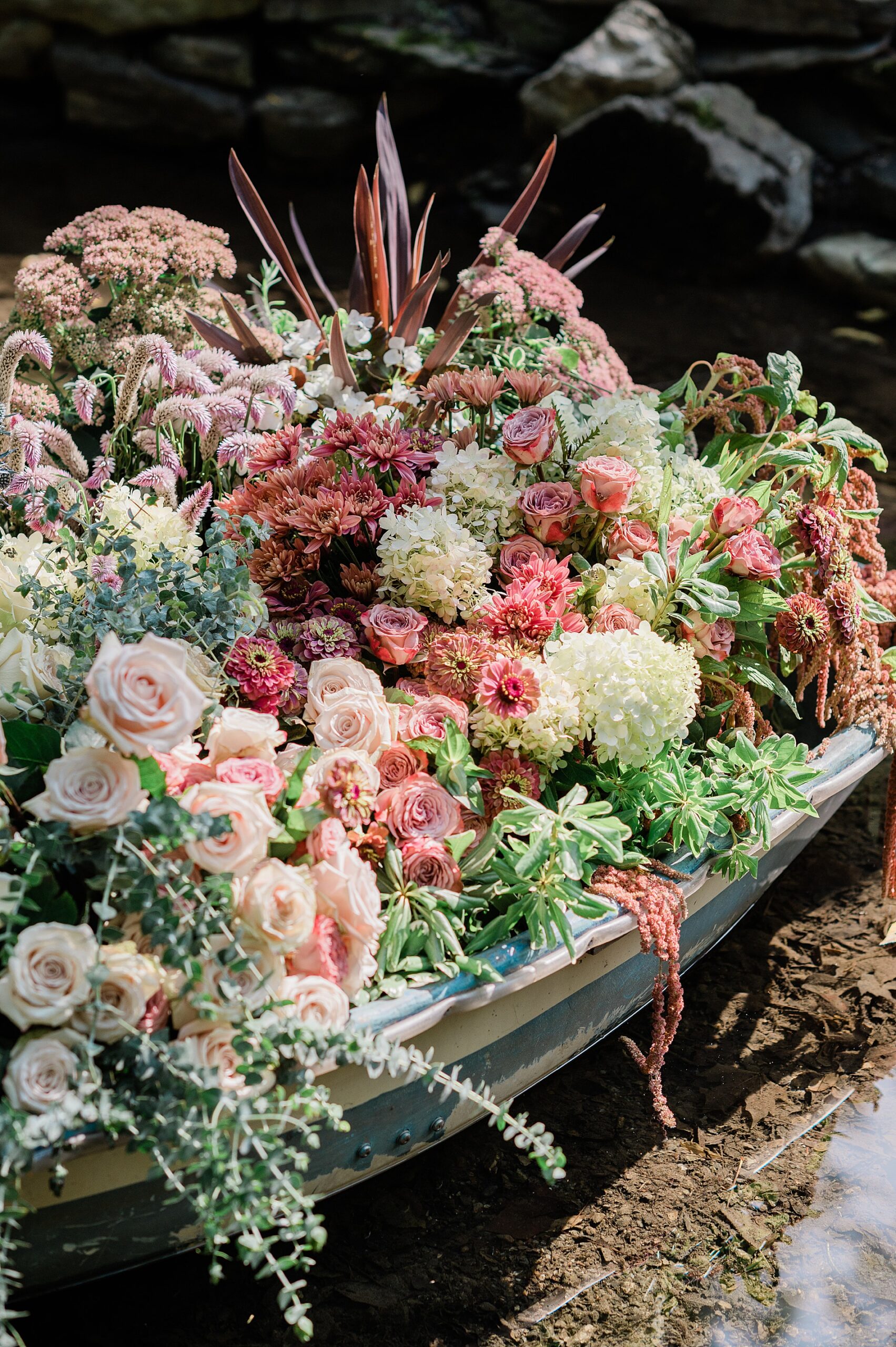 enchanting florals overflow boat in riverbed