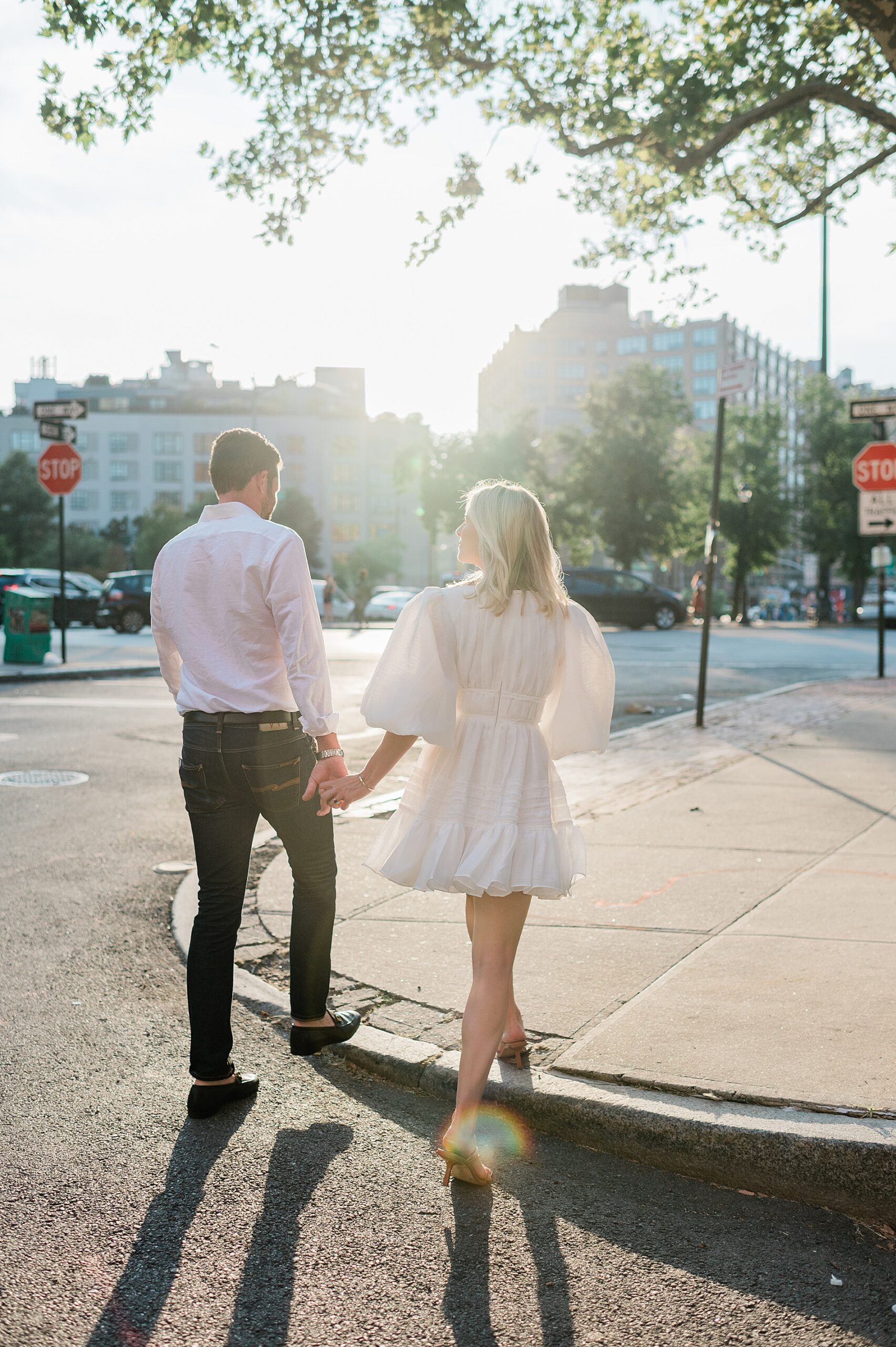 couple wrapped in light on street in SoHo