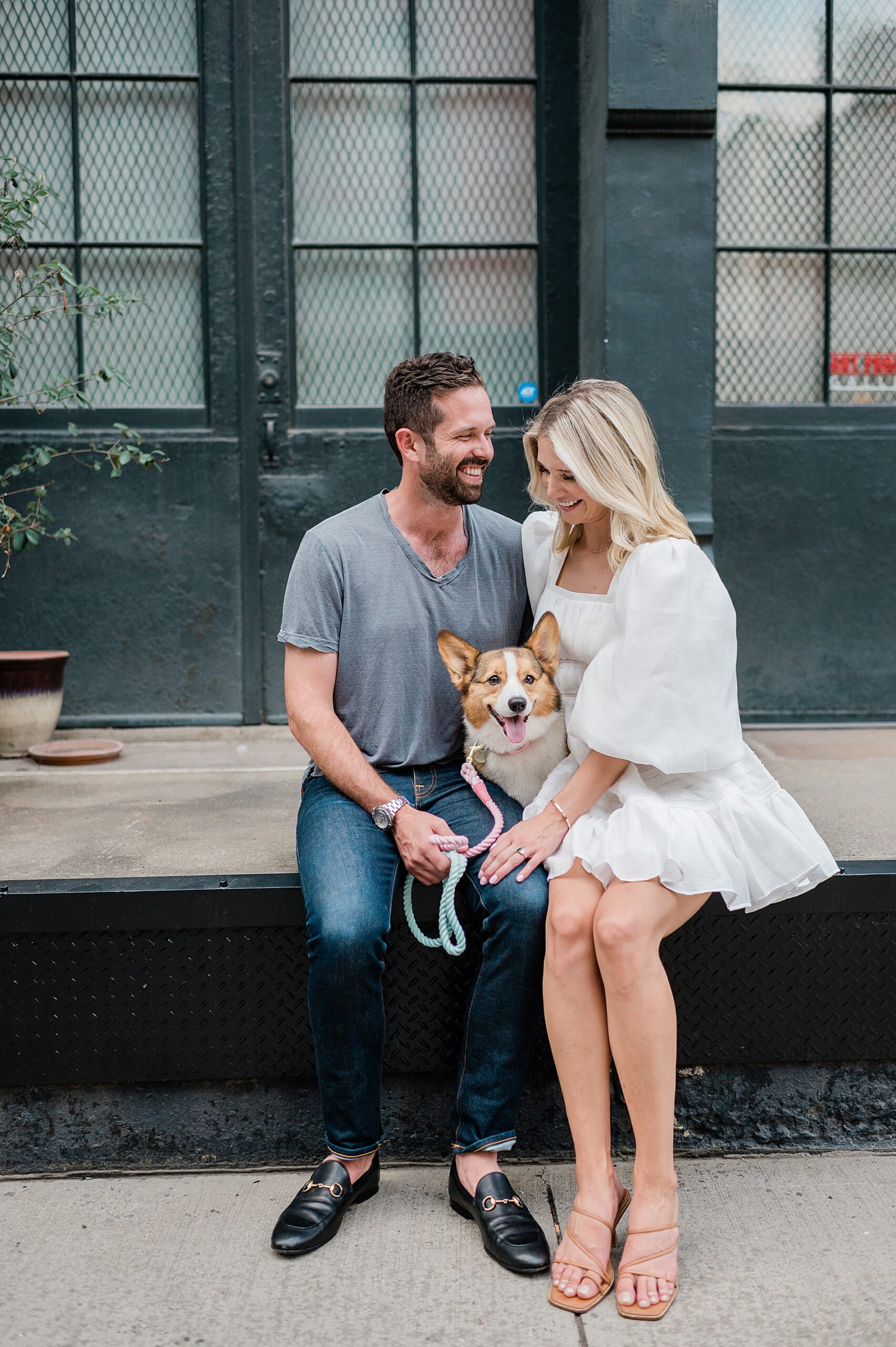 couple sit with their dog during engagement session