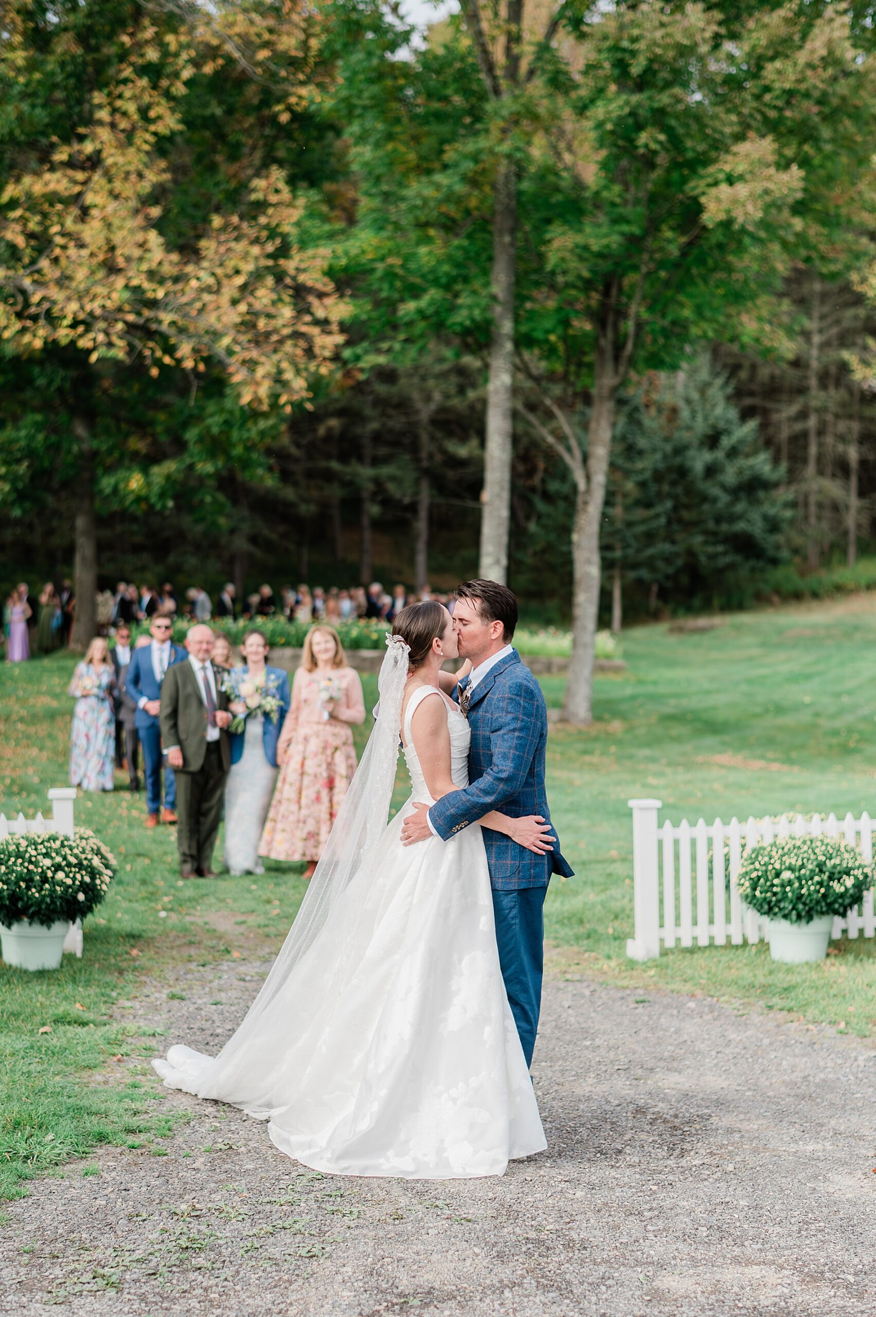 bride and groom kiss as they exit wedding ceremony