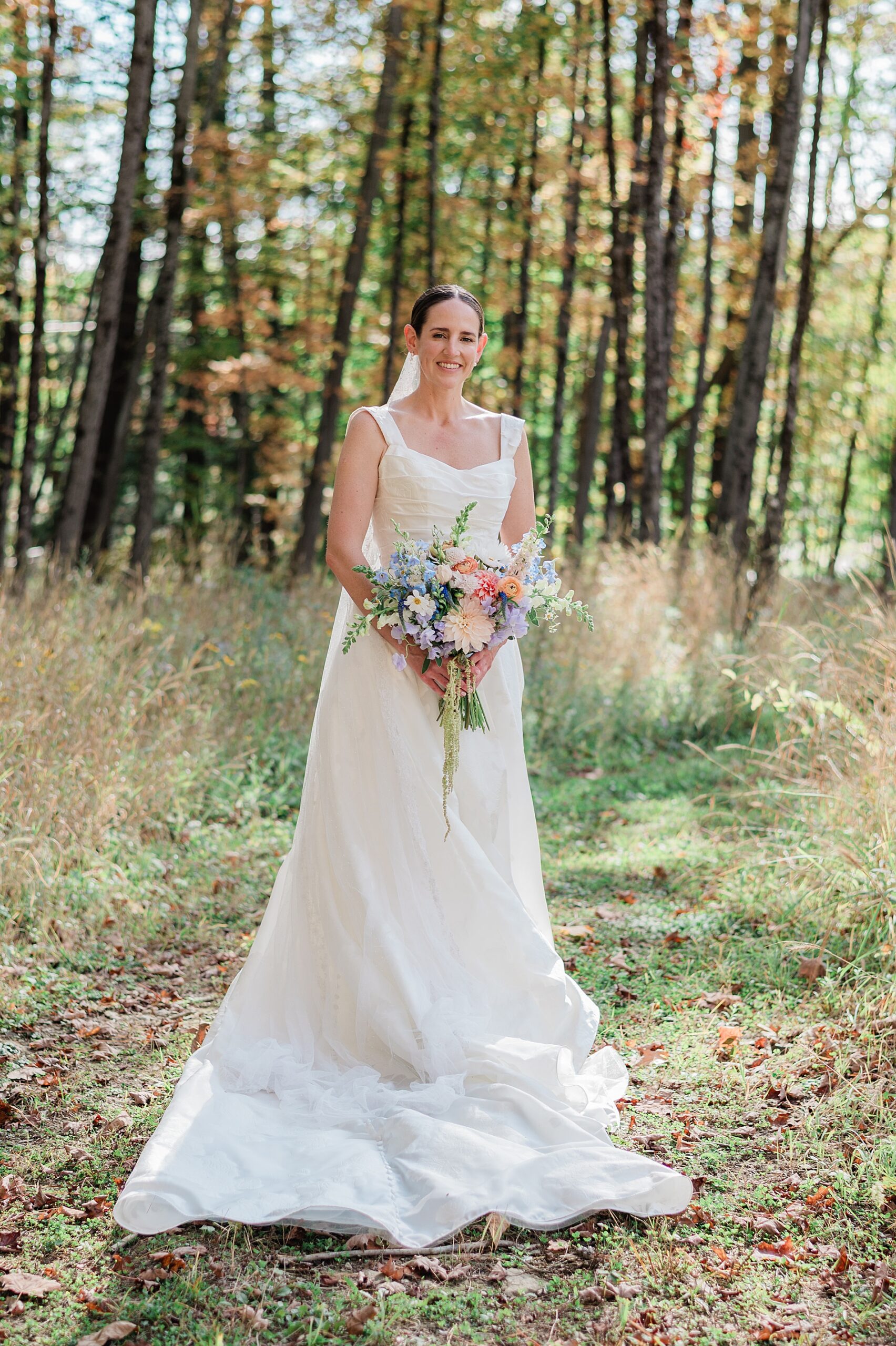 bride holding summer bouquet of flowers
