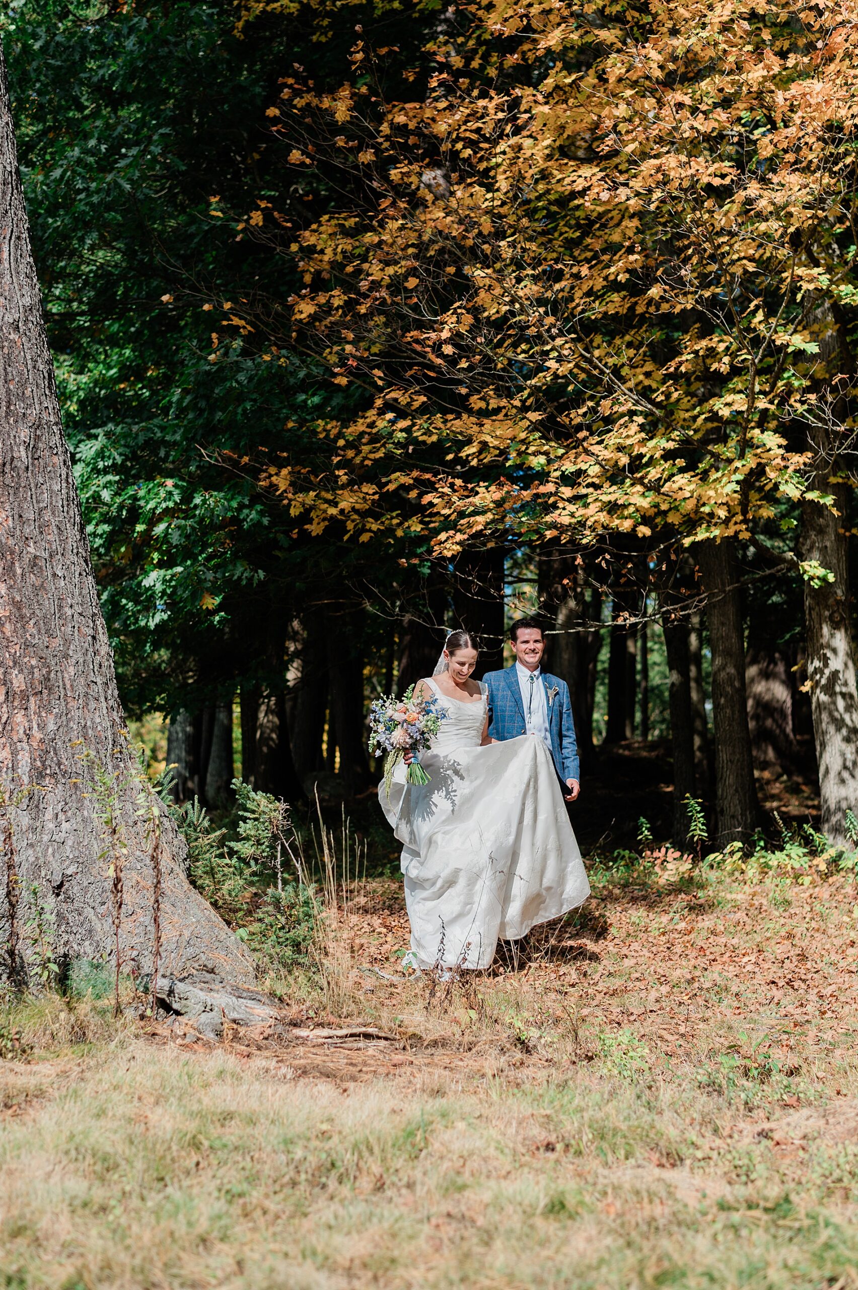 bride and groom walking out of the woods