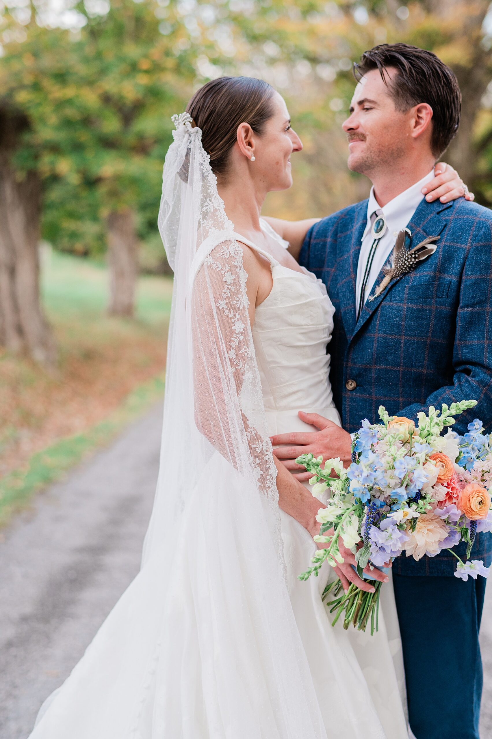 bride and groom look at each other during wedding photos