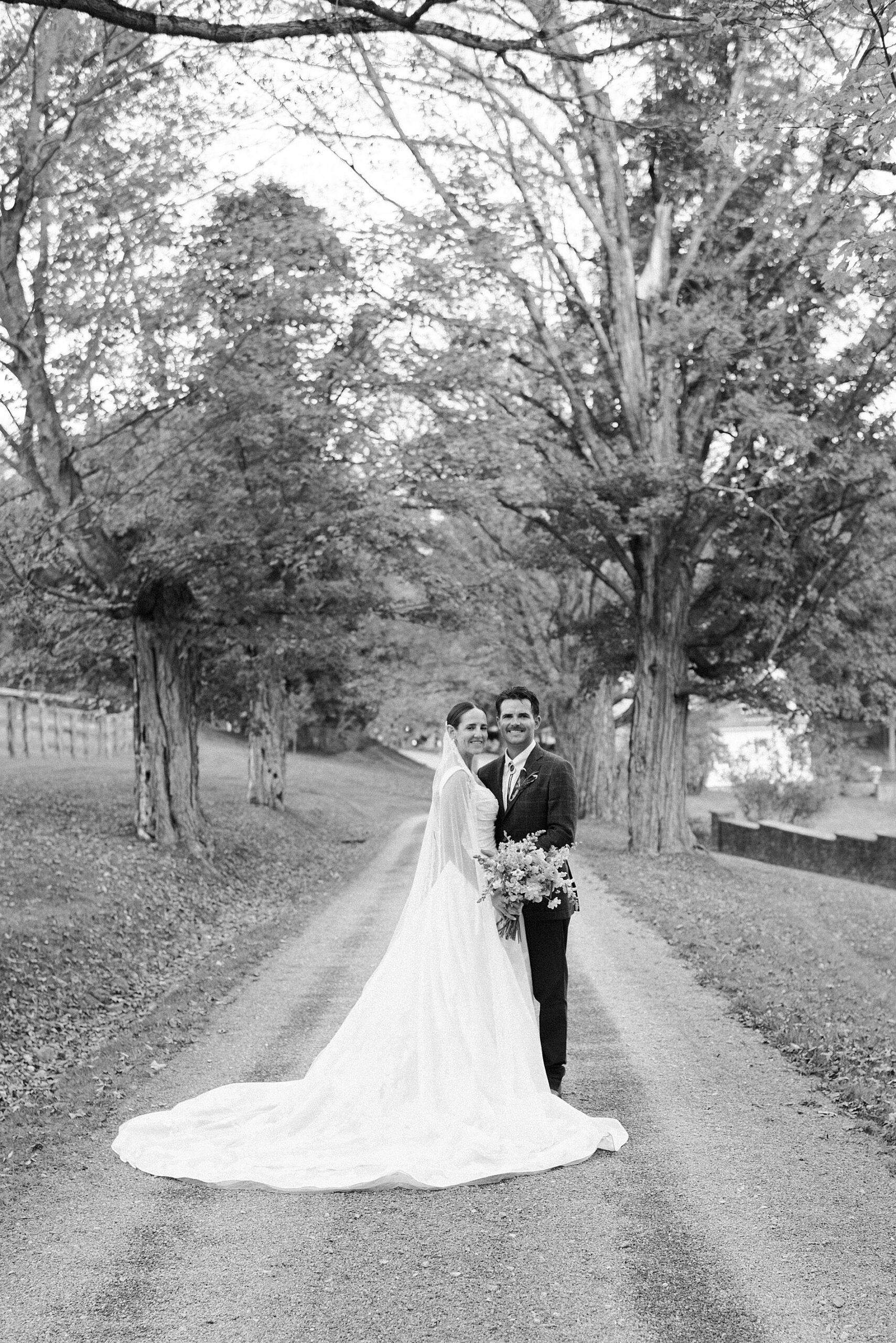bride and groom photos on driveway of private estate
