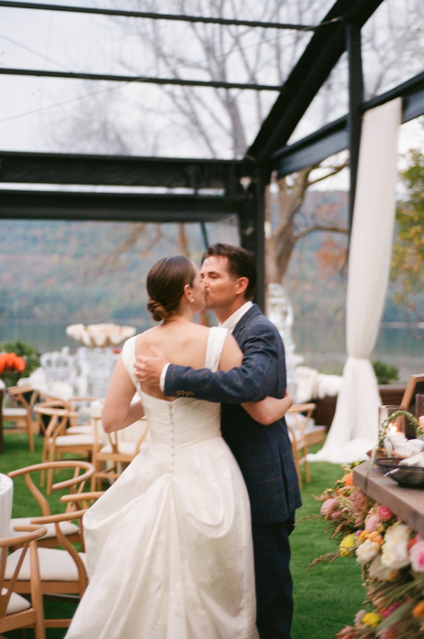 newlyweds kiss inside wedding reception space