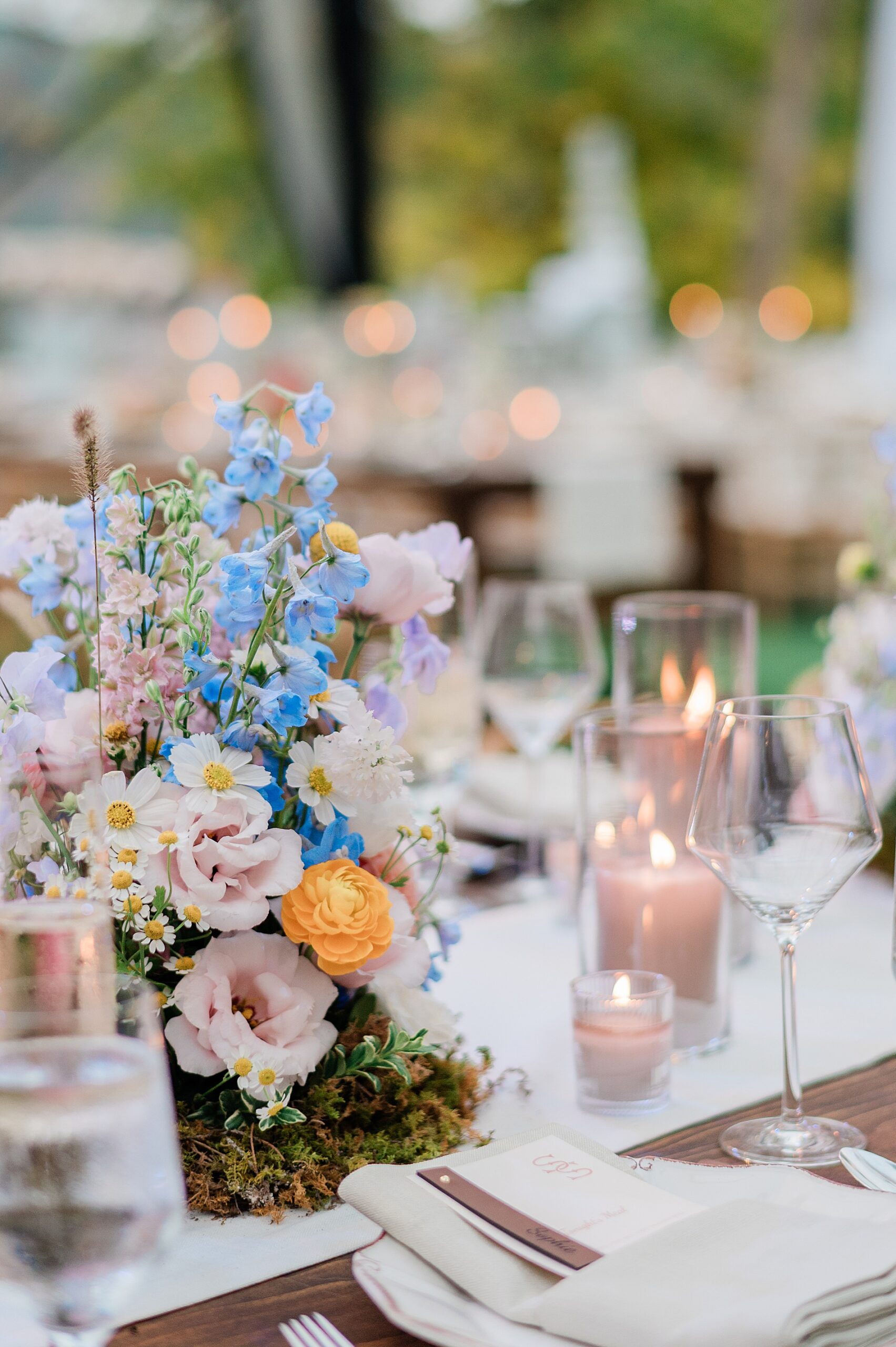 flowers and candlelight decorate tables