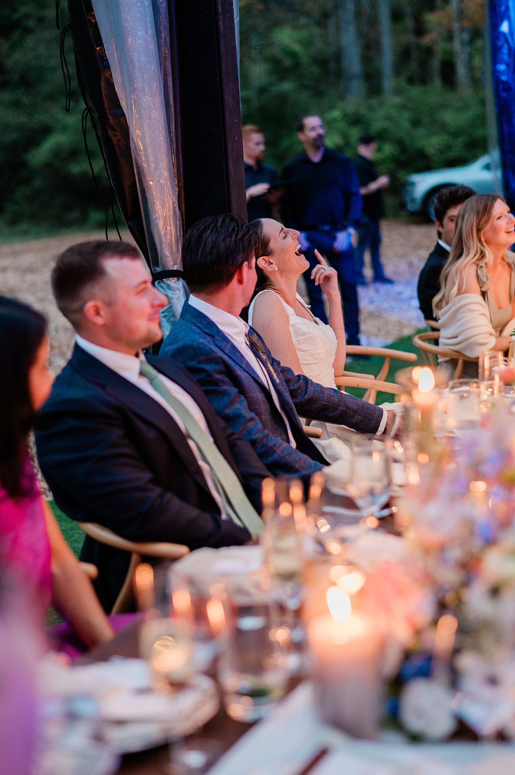 candid photos of couple laughing during wedding toast