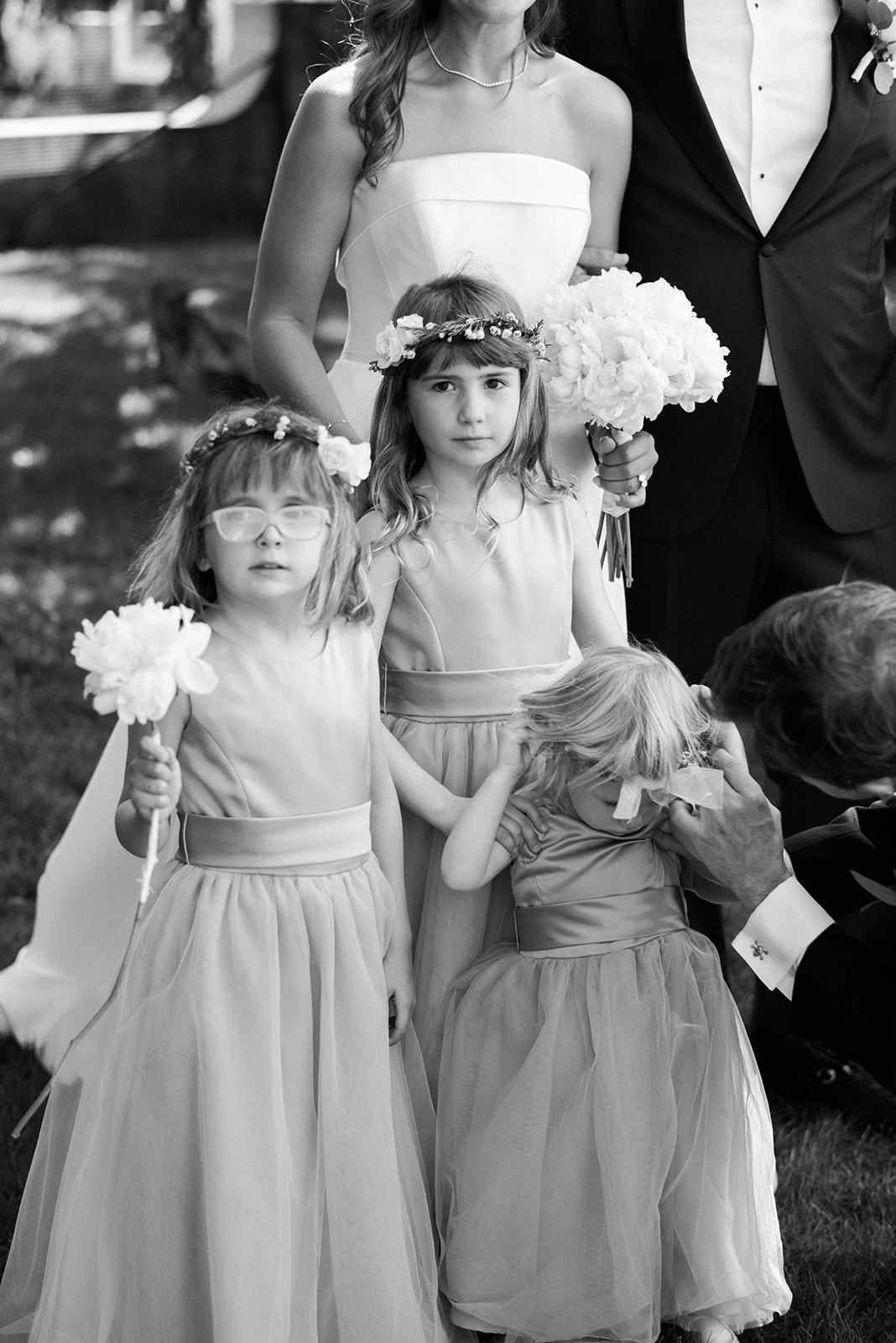 three flower girls stand by bride and groom 
