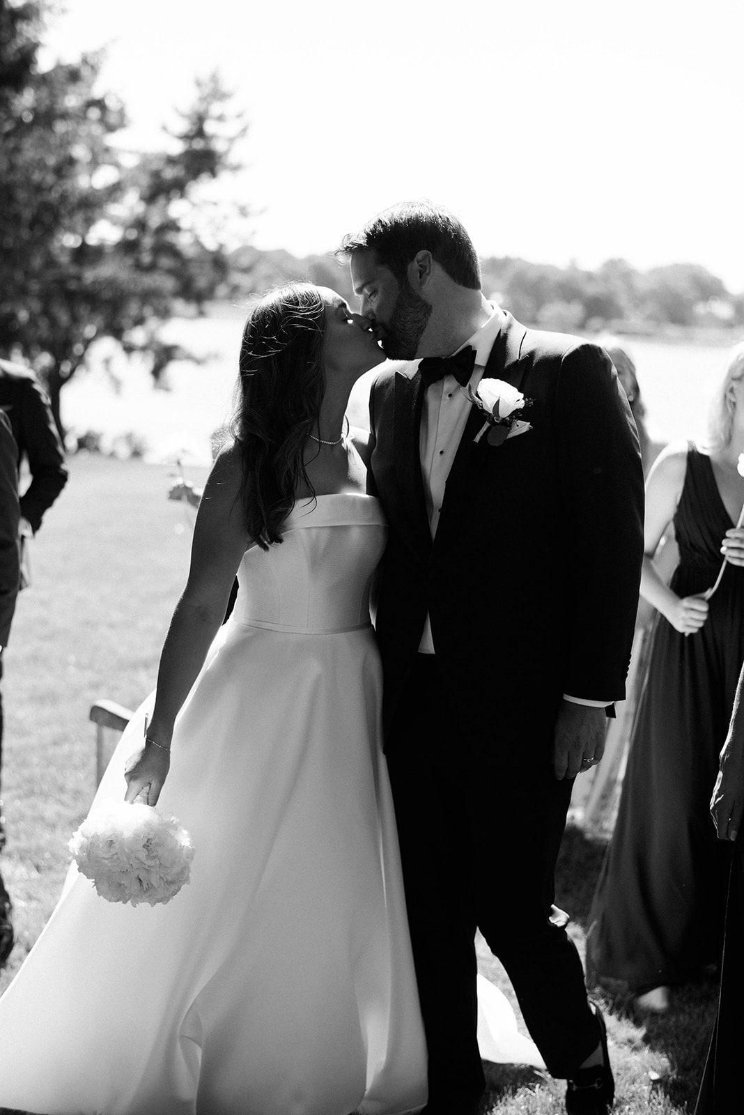 bride and groom kiss at waterfront wedding ceremony at Riverside Yacht Club