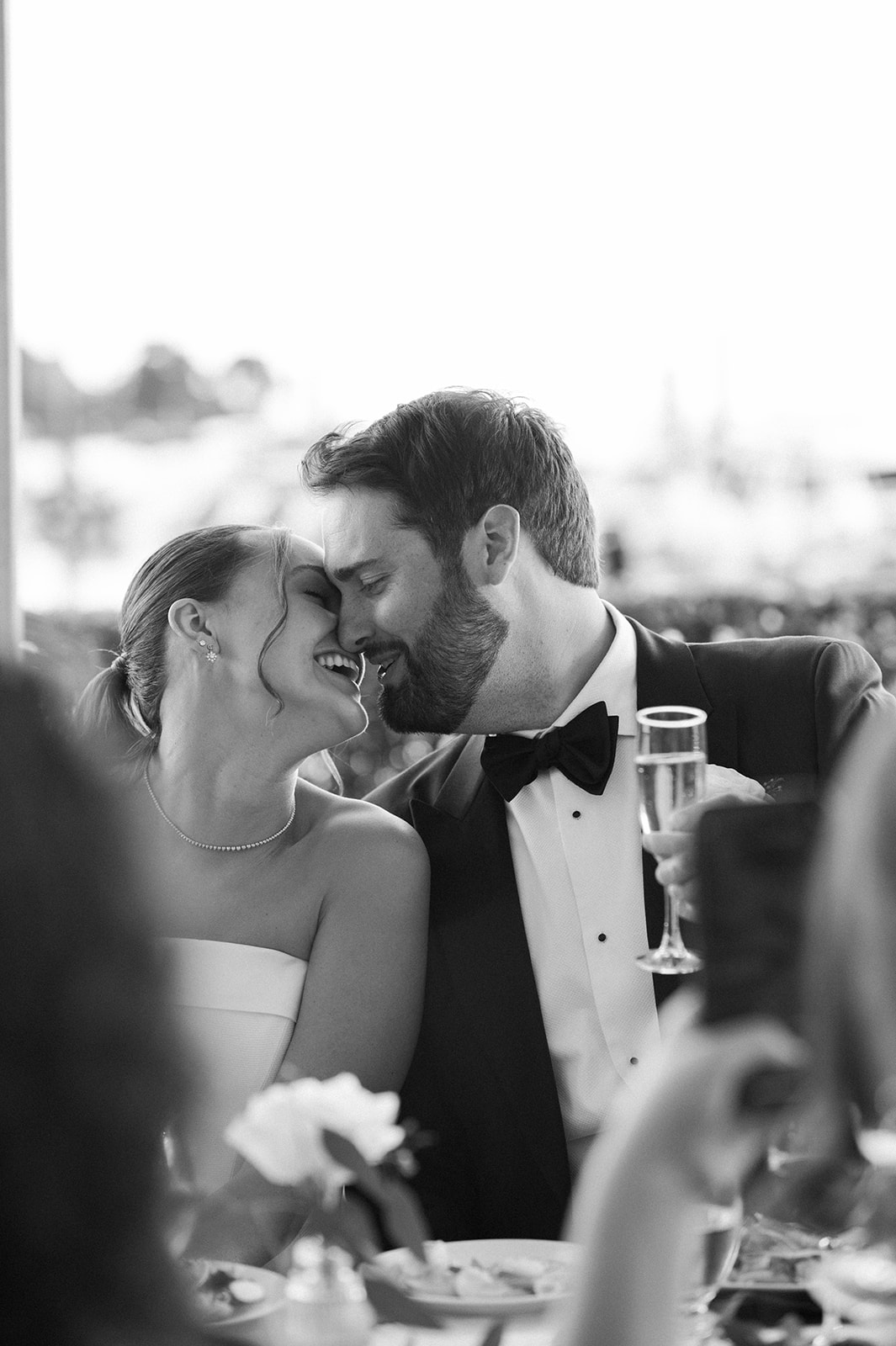 candid wedding portraits of newlyweds at reception table