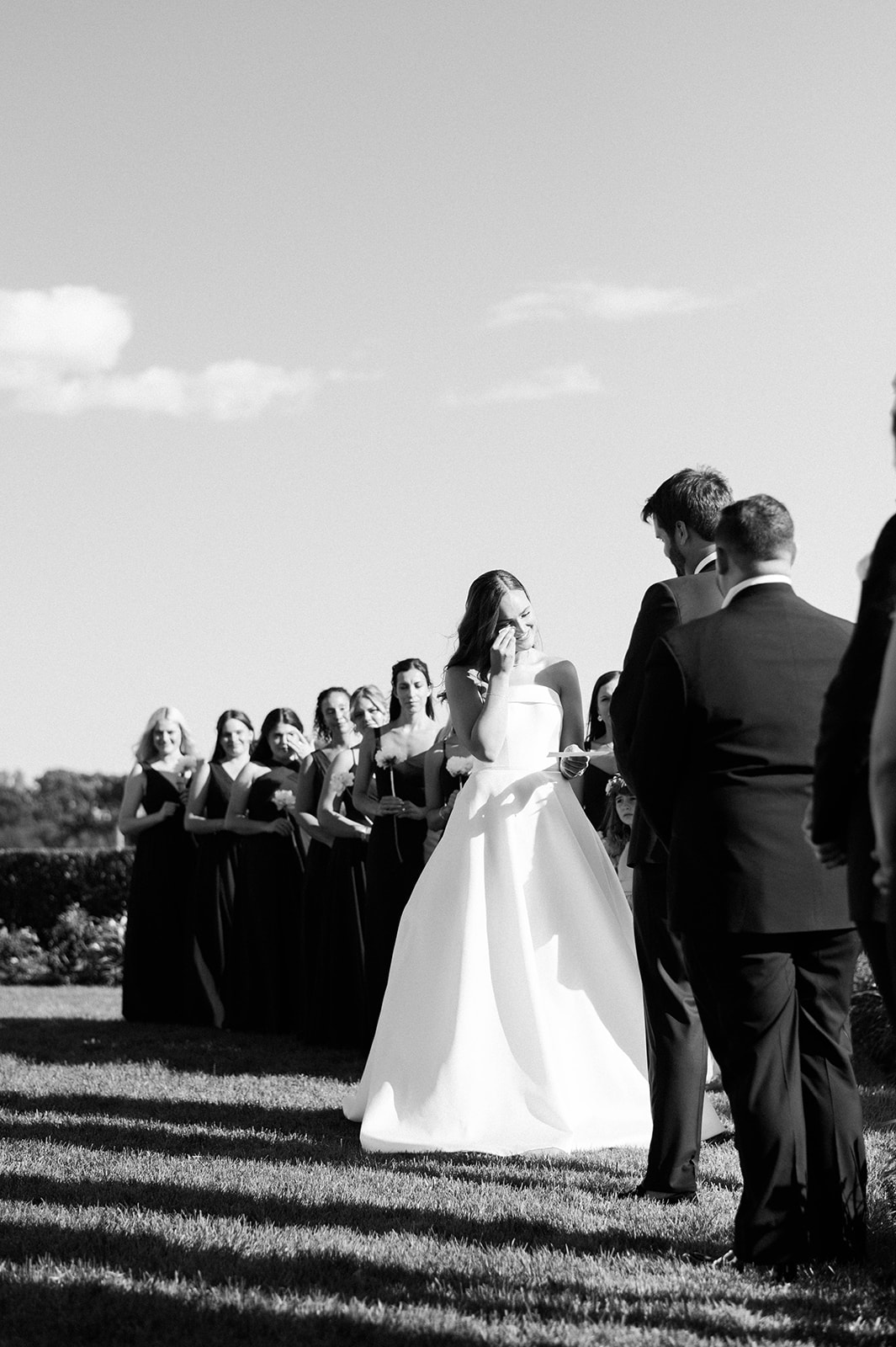 bride wipes away tears during Riverside Yacht Club Wedding ceremony