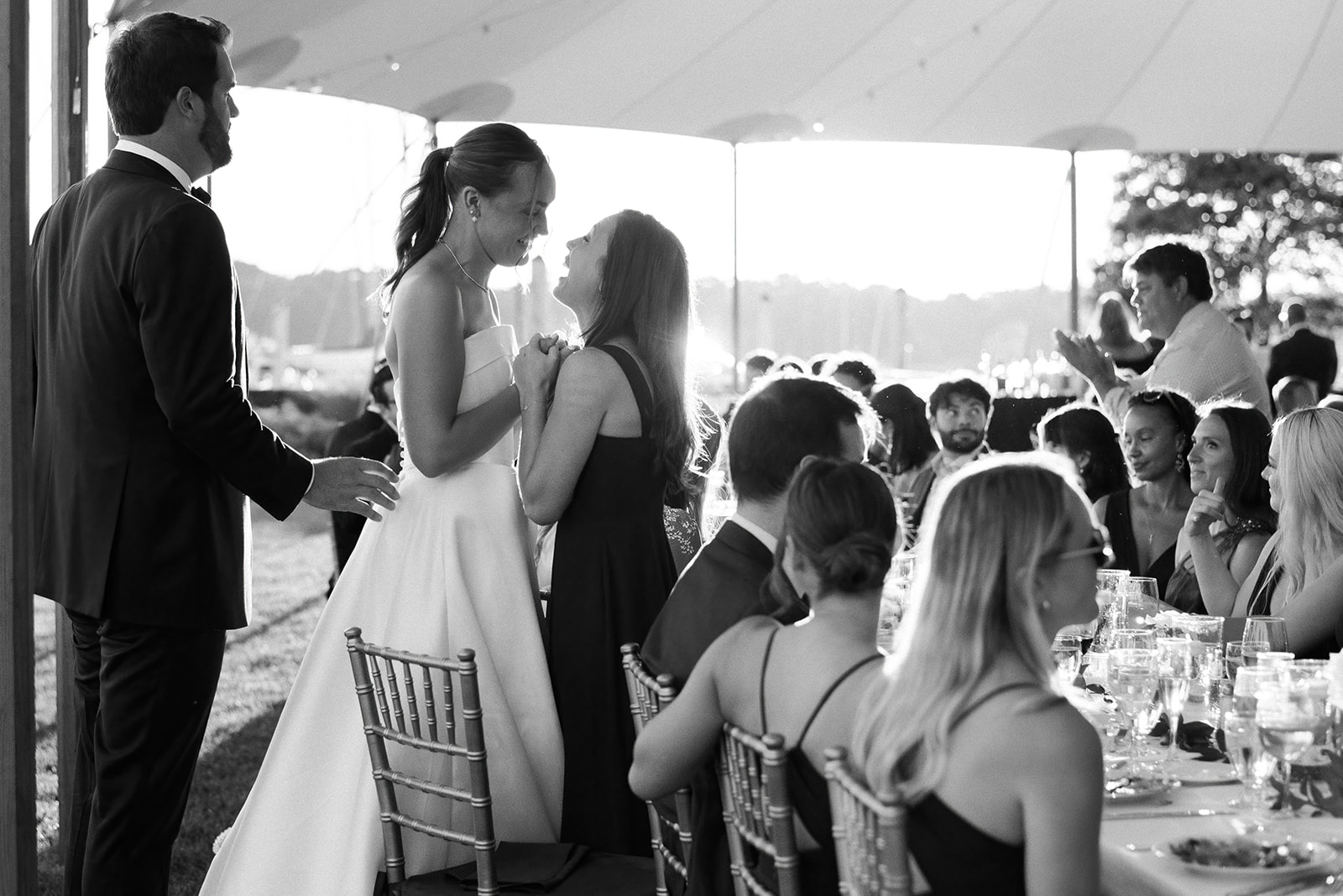 candid moment of bride with friend at reception 