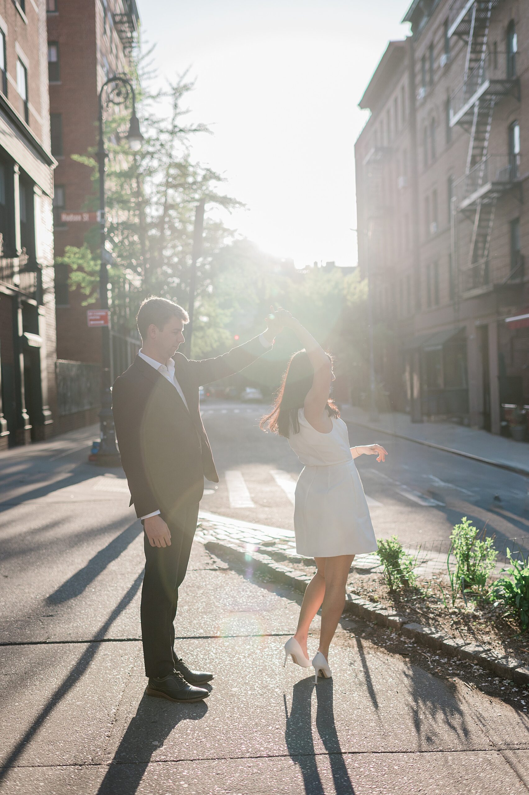 guy twirls his fiancé during West Village Engagement Session in NYC