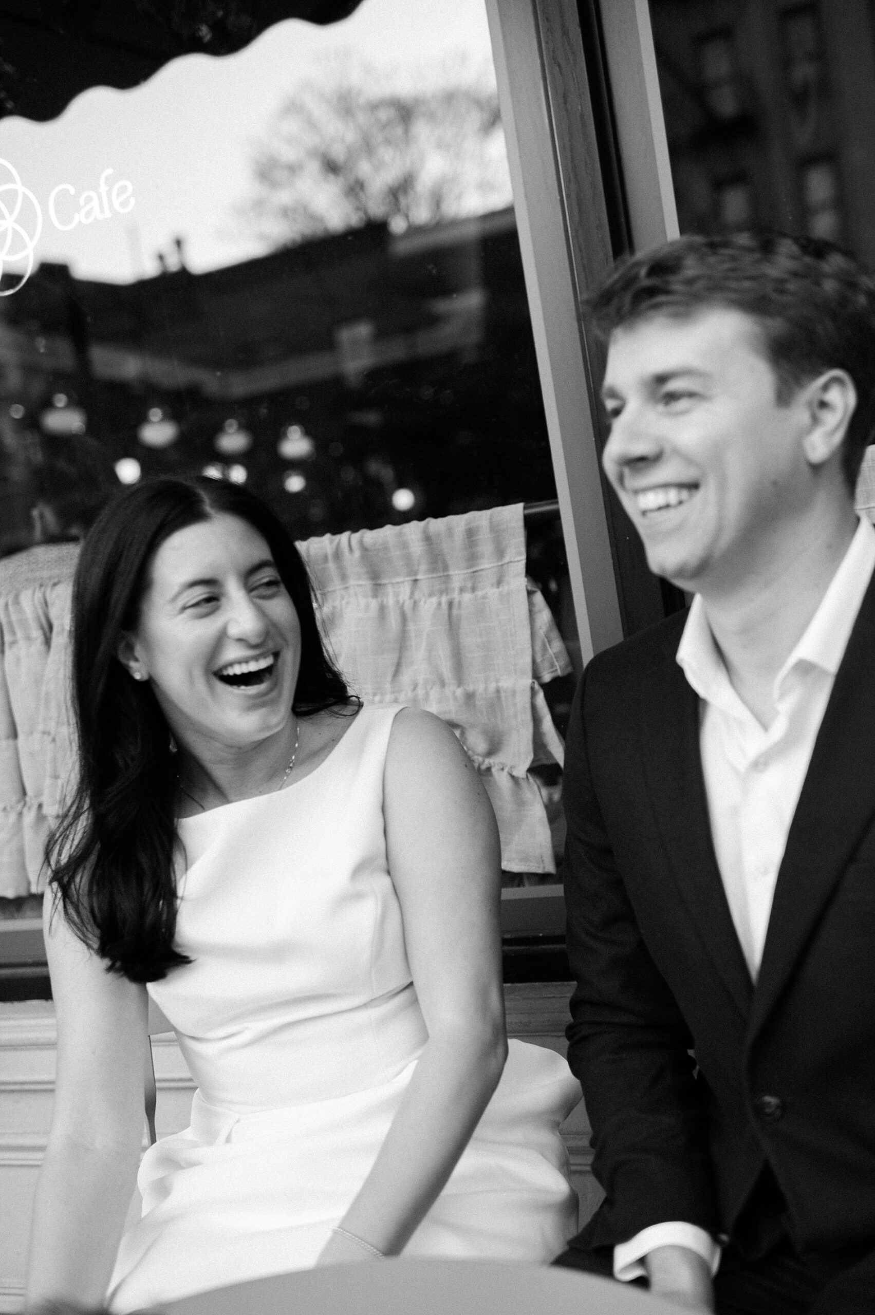 candid engagement photos of couple laughing