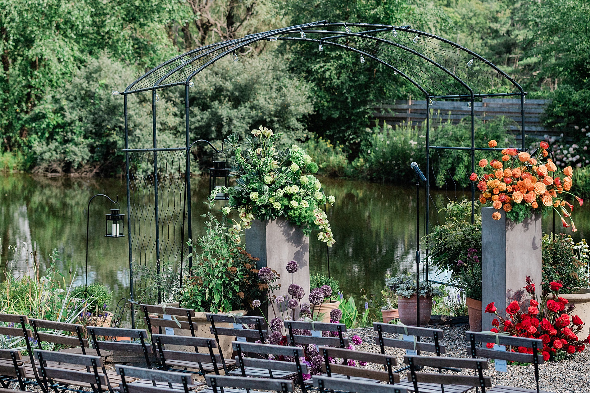 outdoor wedding ceremony facing the water with colorful flowers