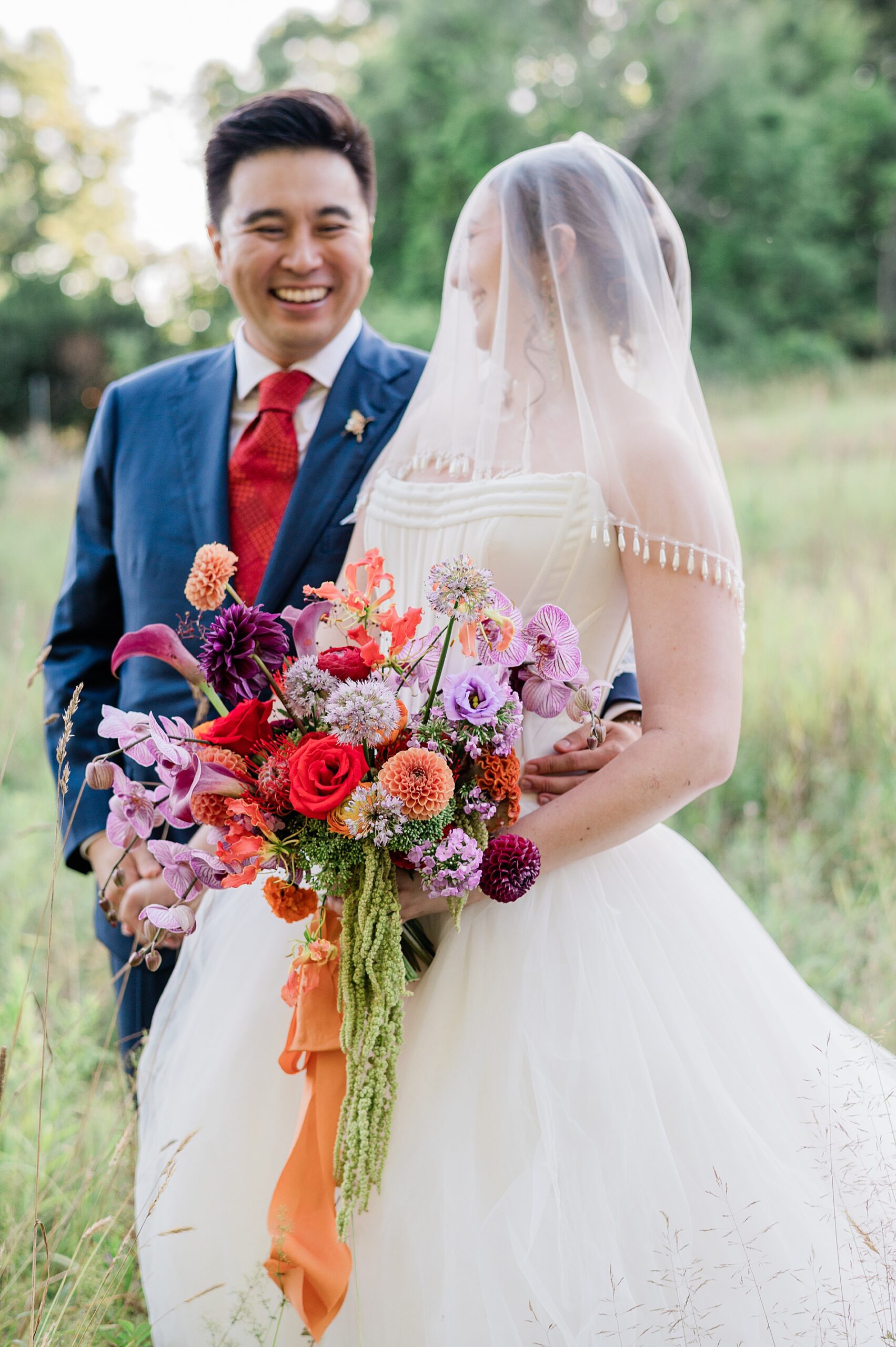 romantic wedding portraits with bride holding colorful bouquet