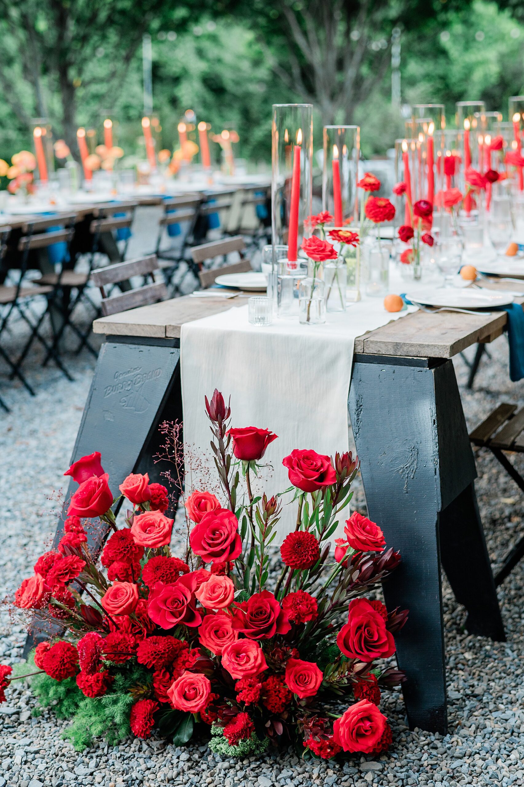 red bouquet of roses at foot of table