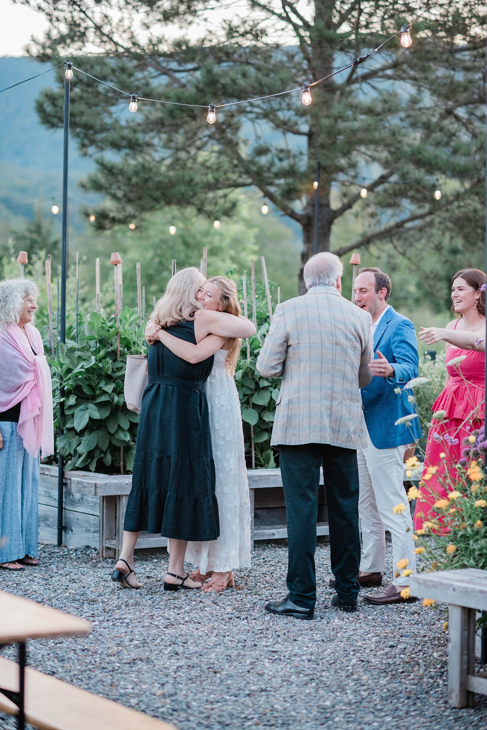 guests greet each other as they arrive to welcome party