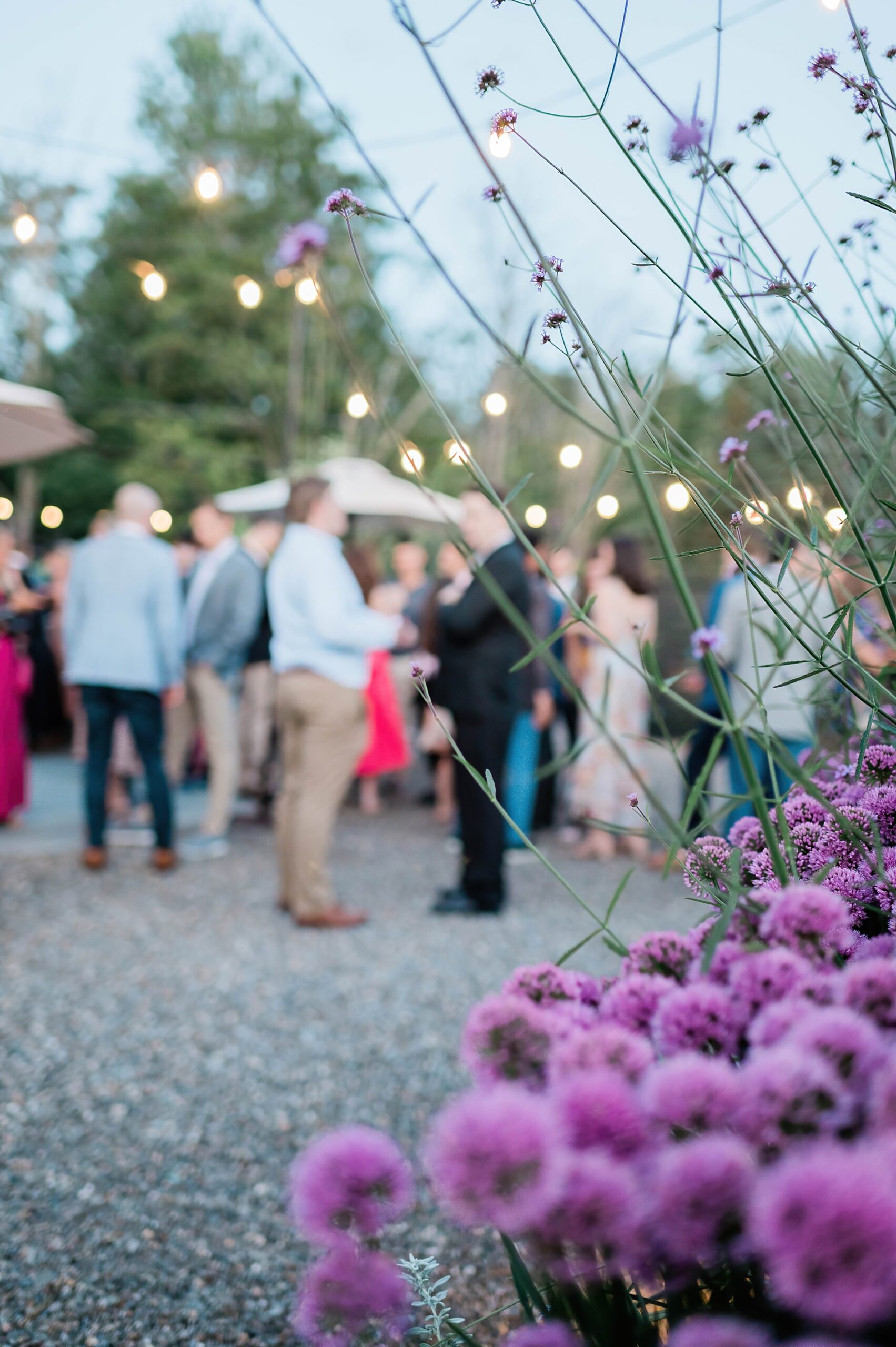 colorful flowers and stringed lights create romantic atmosphere for wedding welcome party