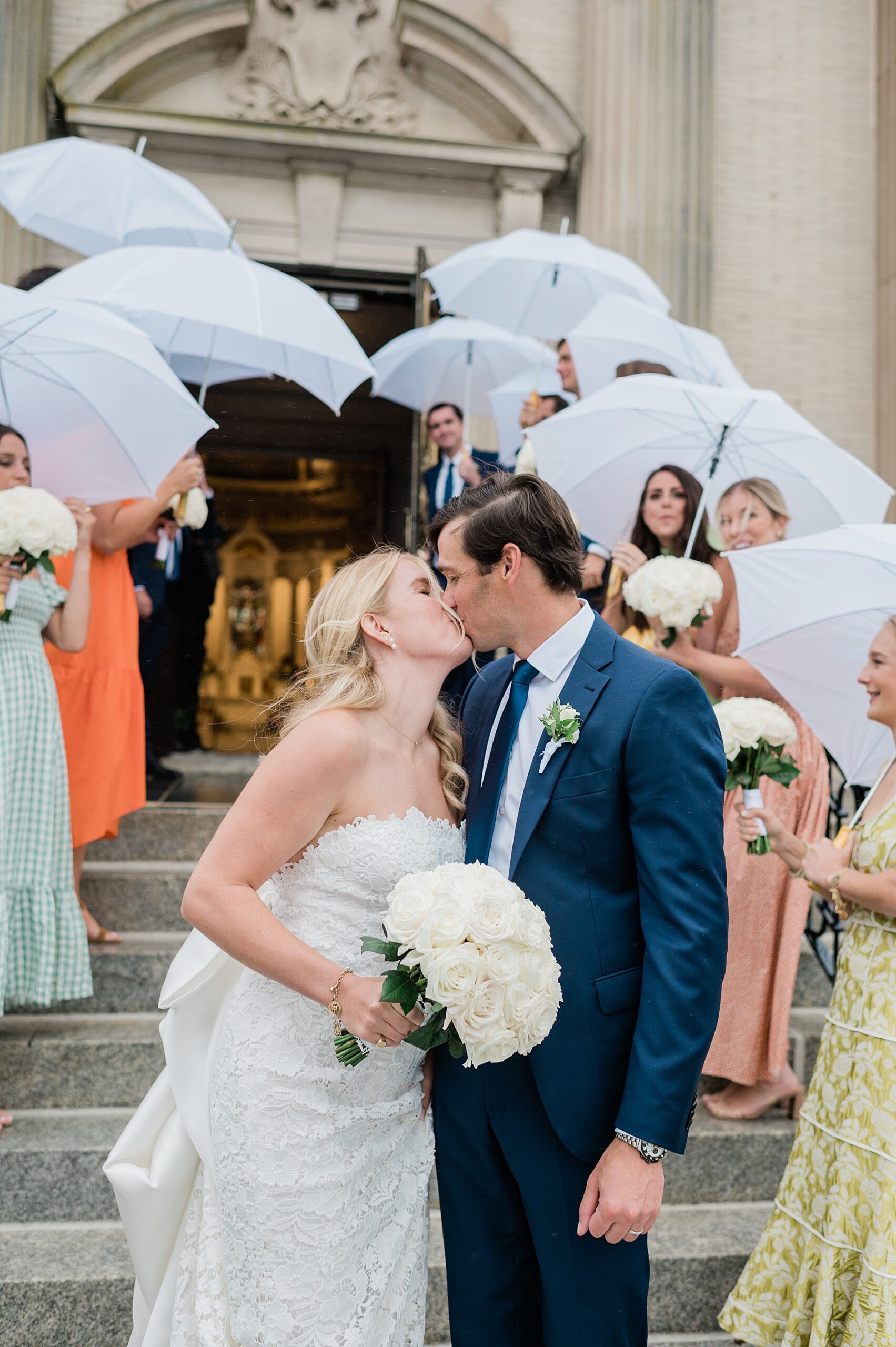 newlyweds kiss outside of church from Rainy Spring Lake Wedding