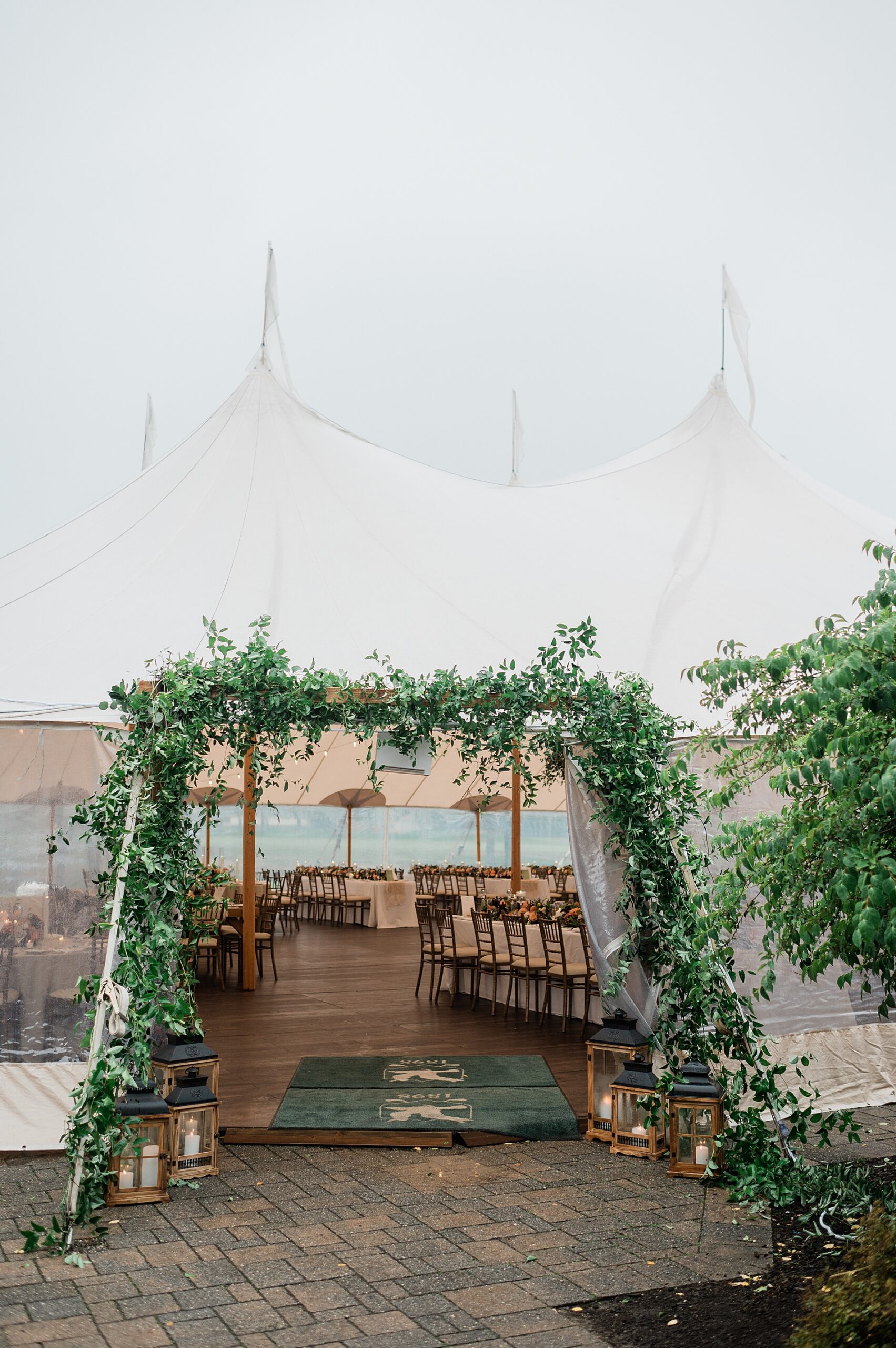 greenery lines the tent opening at reception 