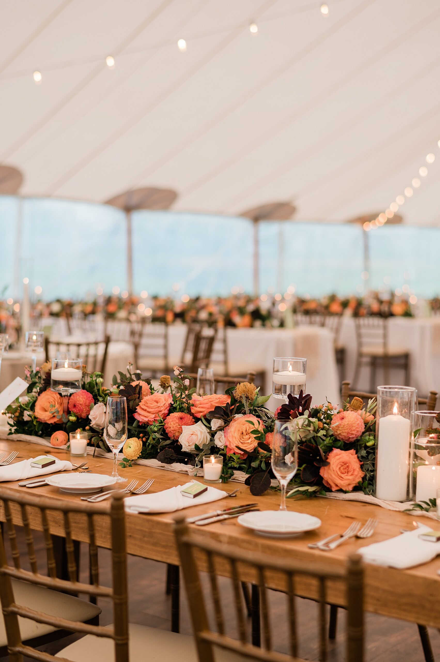 Elegant tented reception with bright, colorful florals 