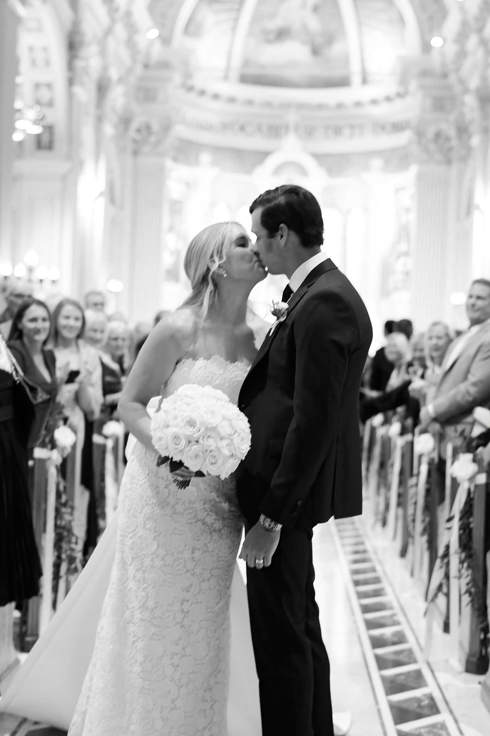 newlyweds kiss as they exit church ceremony 