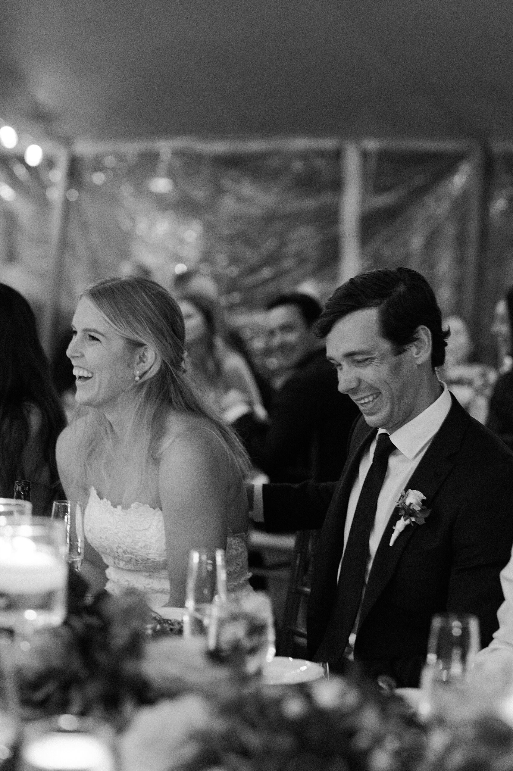 candid reception photos of bride and groom laughing togehter