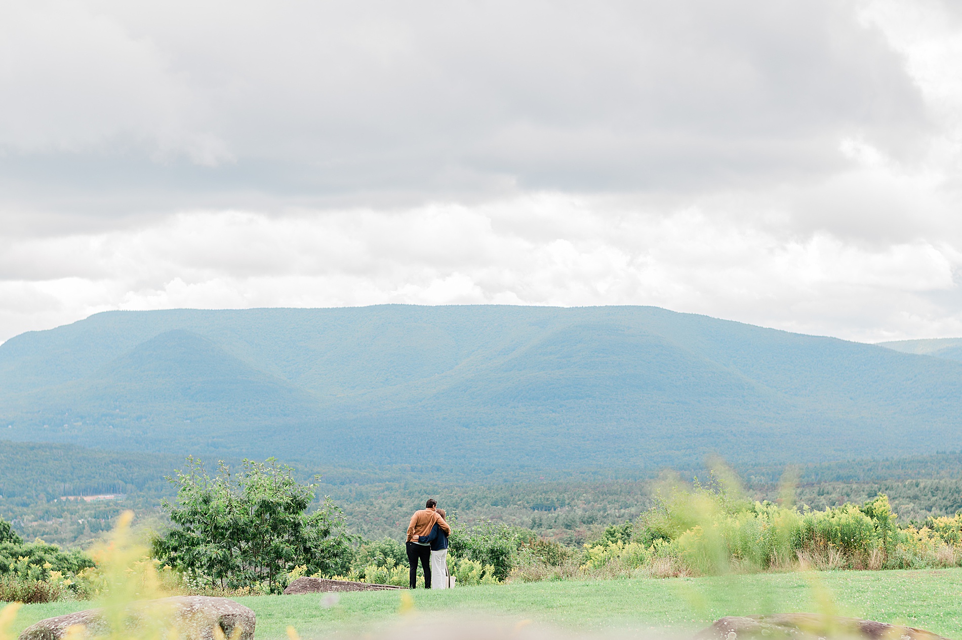 couple looks out over the landscape at the Catskills